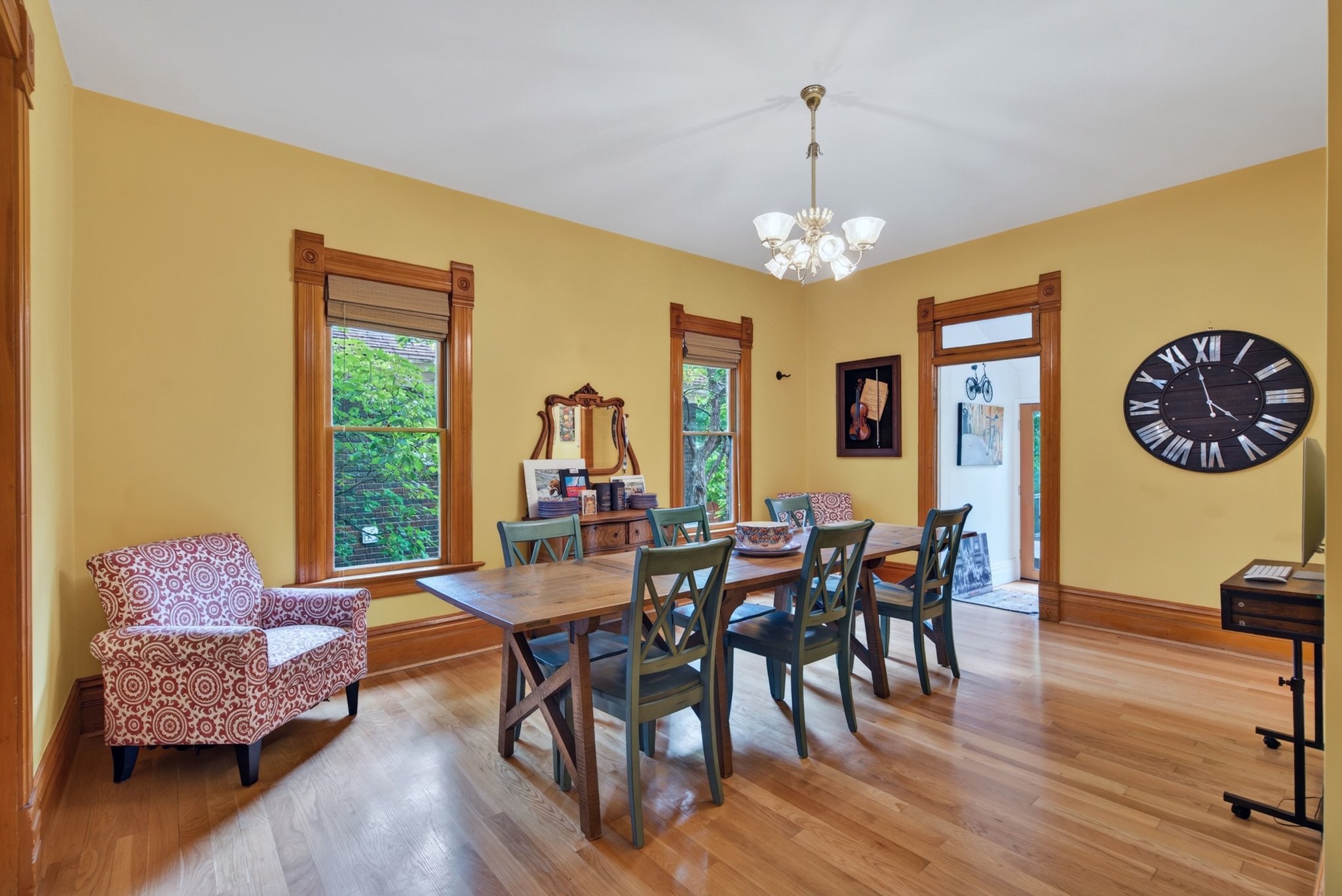 Dining area featuring rich wood-finish flooring and substantial wood trim