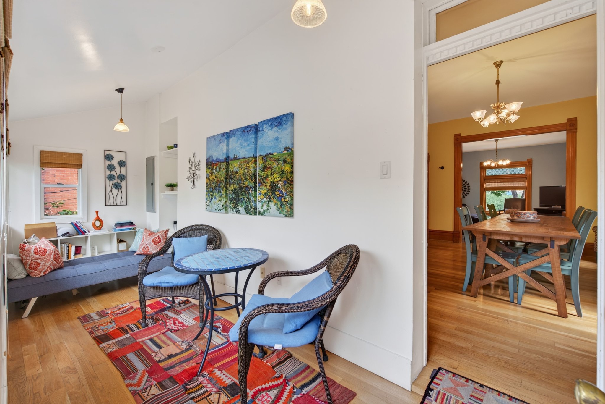 Hardwood flooring extending throughout the living space and into the dining area