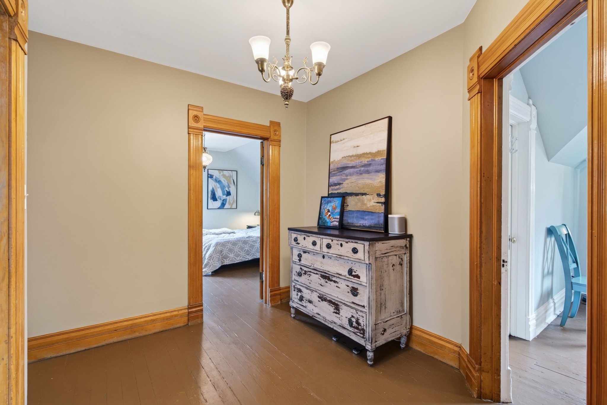 Hallway featuring wood-finish flooring and light-toned walls
