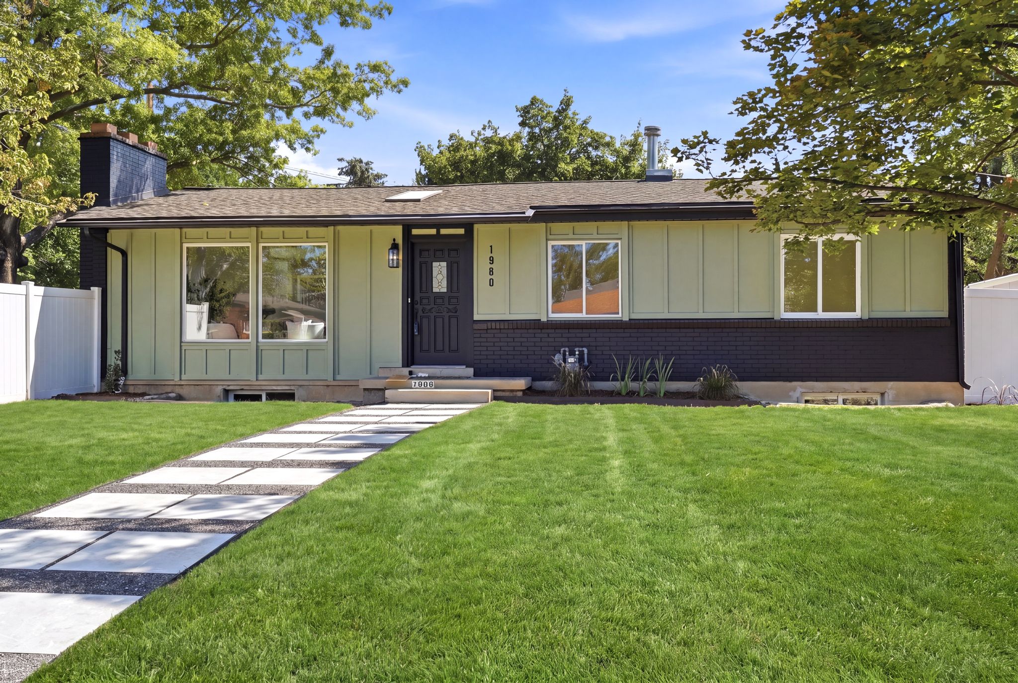 Contemporary exterior featuring board and batten siding, brick detailing, and a shingled roof