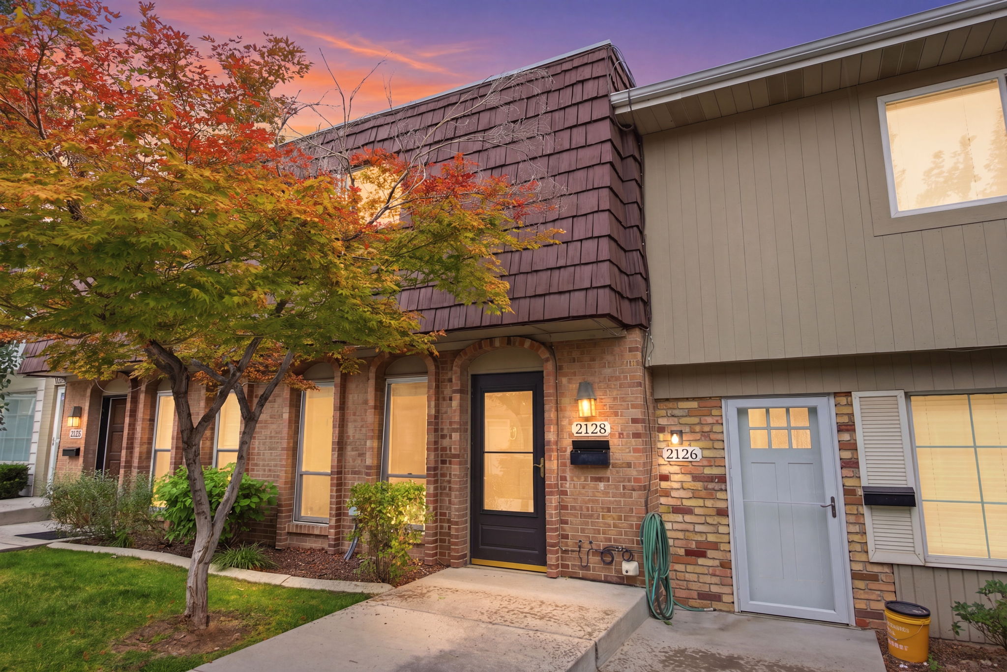 Brick and siding exterior with a textured shingle roofline