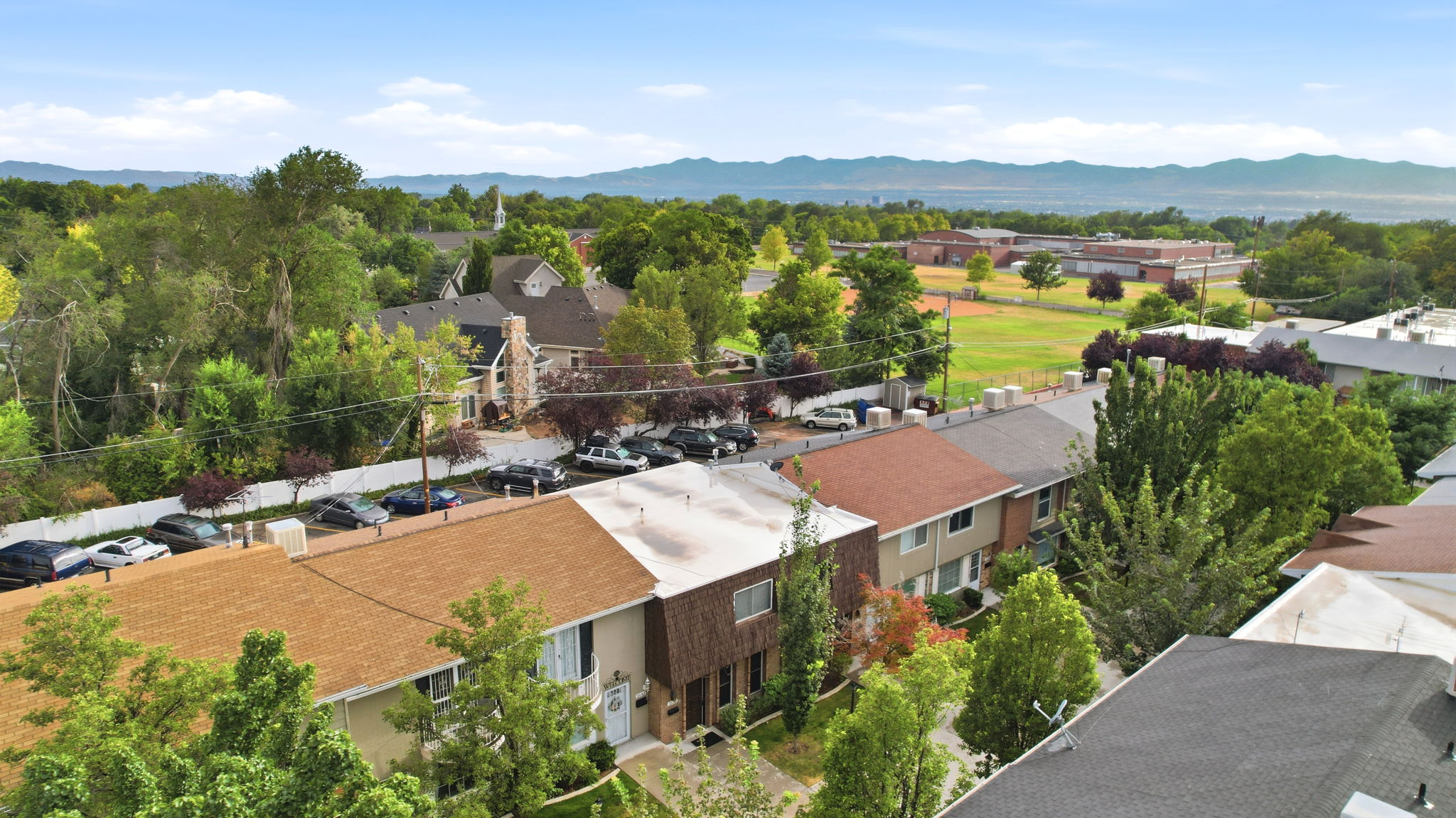 Aerial perspective showcasing residential properties with varying rooflines and exterior finishes