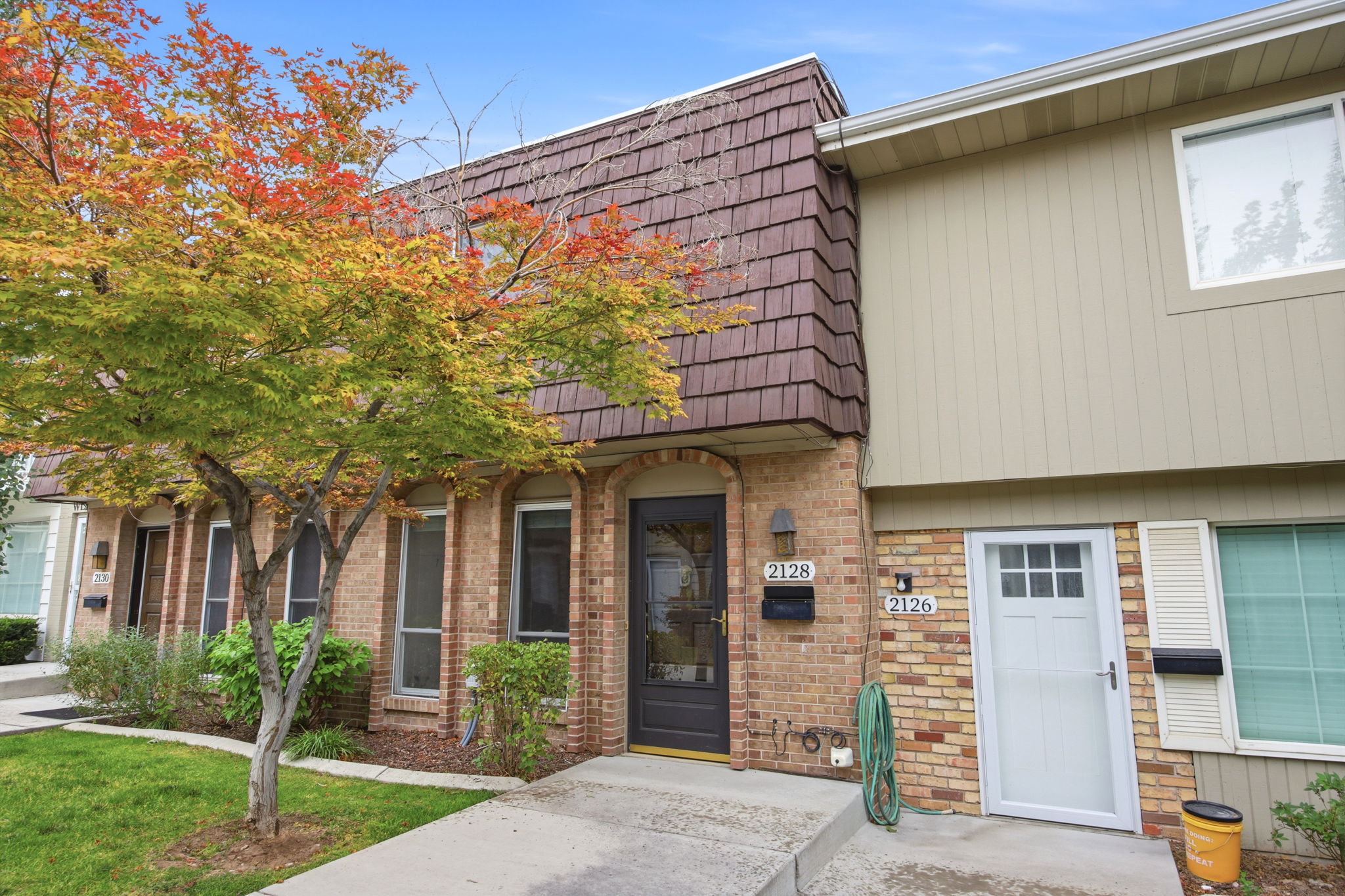 Brick facade townhouse with a gabled roofline