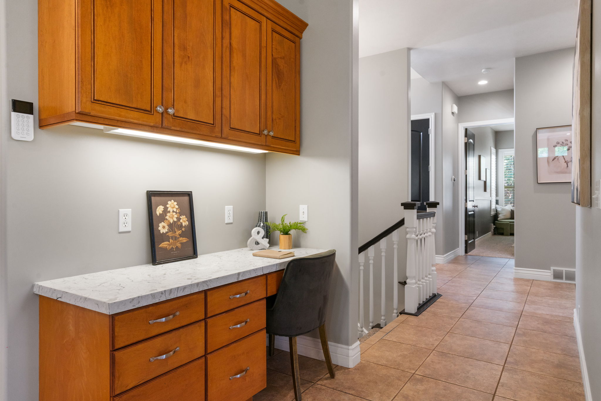 Built-in kitchen desk area with extra cabinetry and under-cabinet lighting.