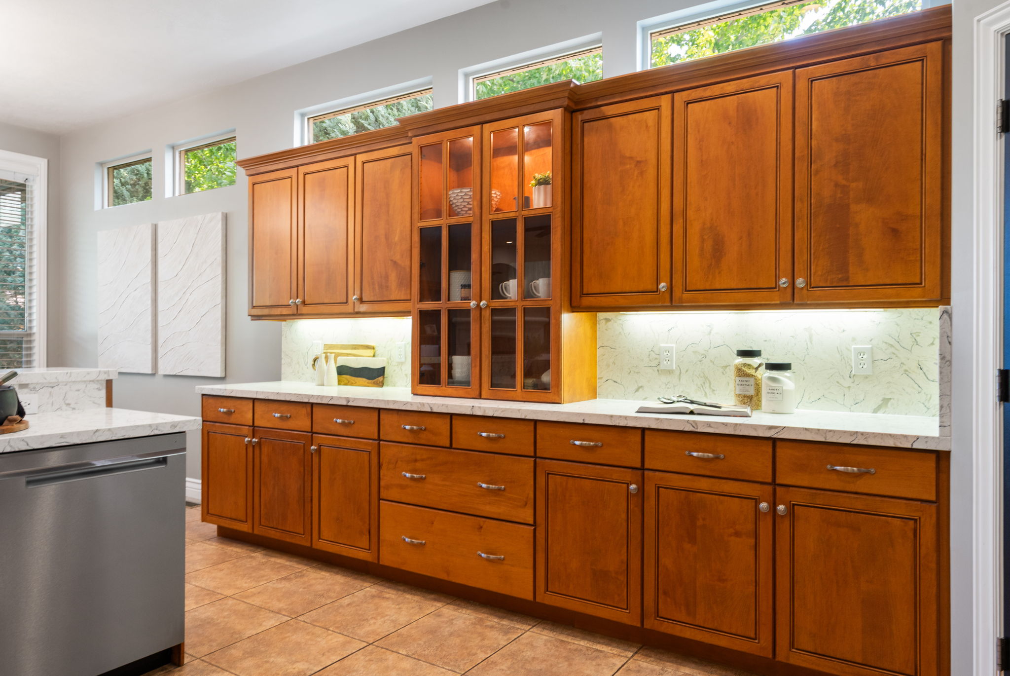 Designed for gathering, this generous back counter is ideal for laying out a dessert bar or charcuterie boards, under mount & cabinet lighting elevates the space.