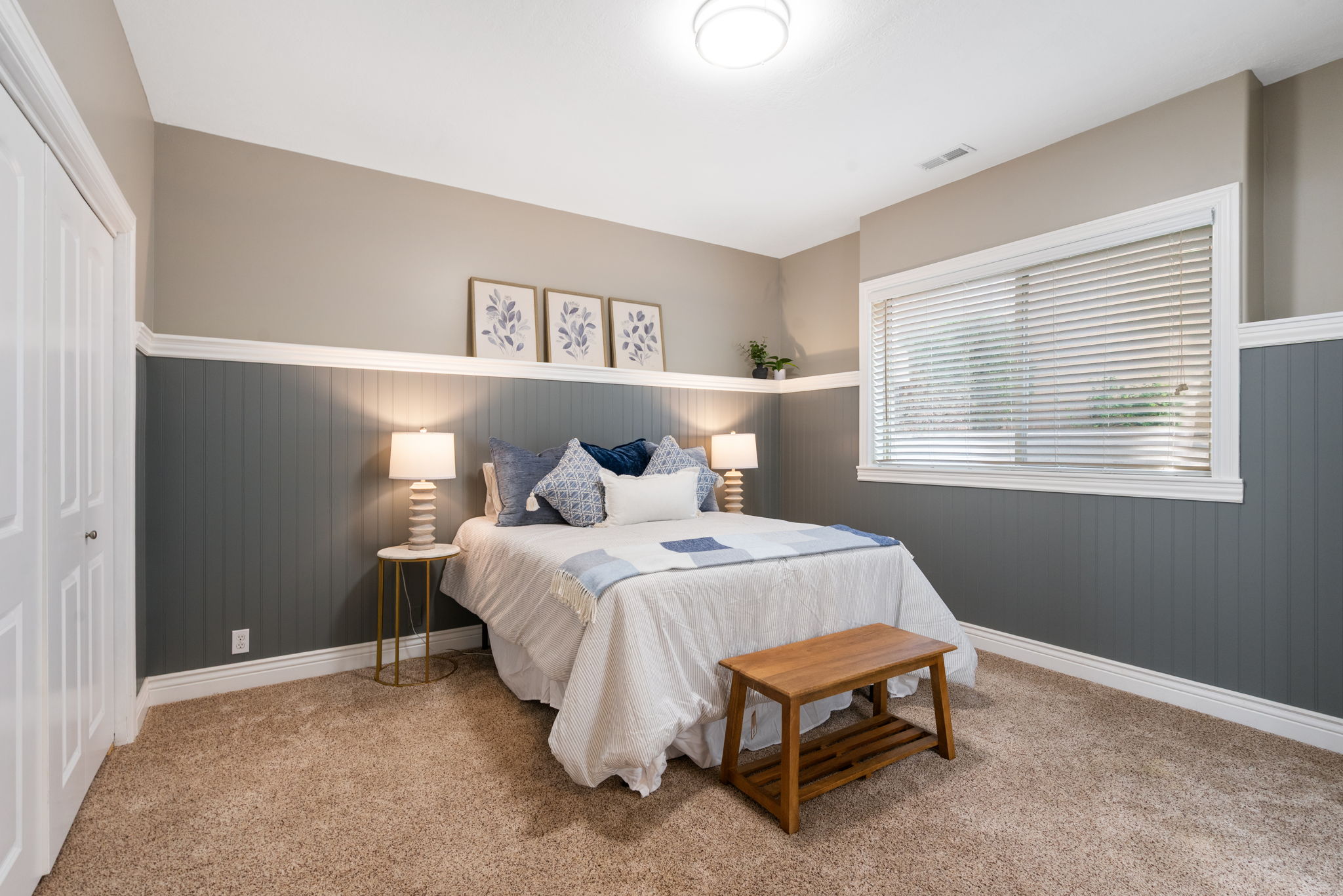 Bedroom 3 is on lower level has custom wainscoting with a ledge, grade level window provides natural light, large closet.