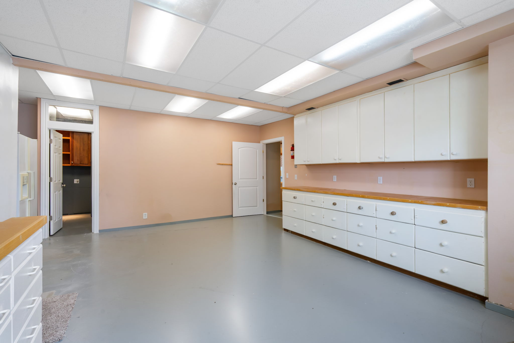Another view of large lower FLEX room. Currently a workshop but can be converted into a 5th bedroom or even better a second kitchen (buyer to verify)