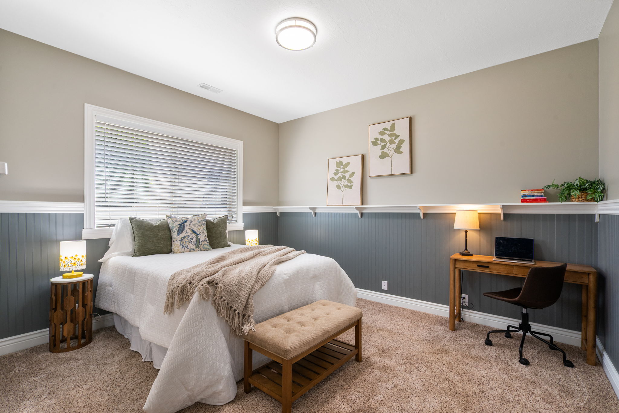 Bedroom 4 is on lower level has custom wainscoting with a ledge, grade level window provides natural light, large closet.