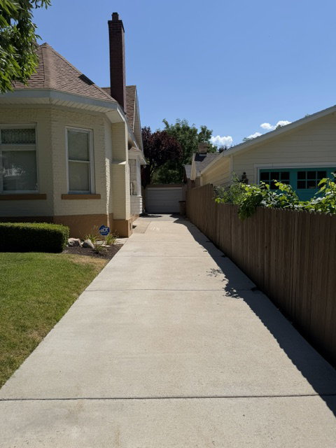 Concrete driveway extending to a rear garage