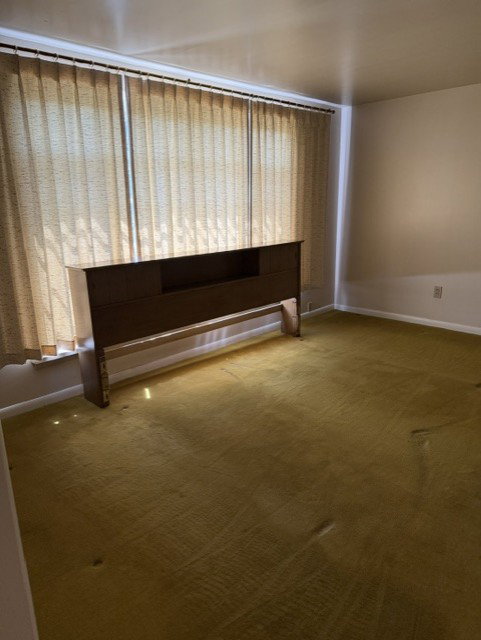 Room featuring wall-to-wall carpeting and neutral painted walls