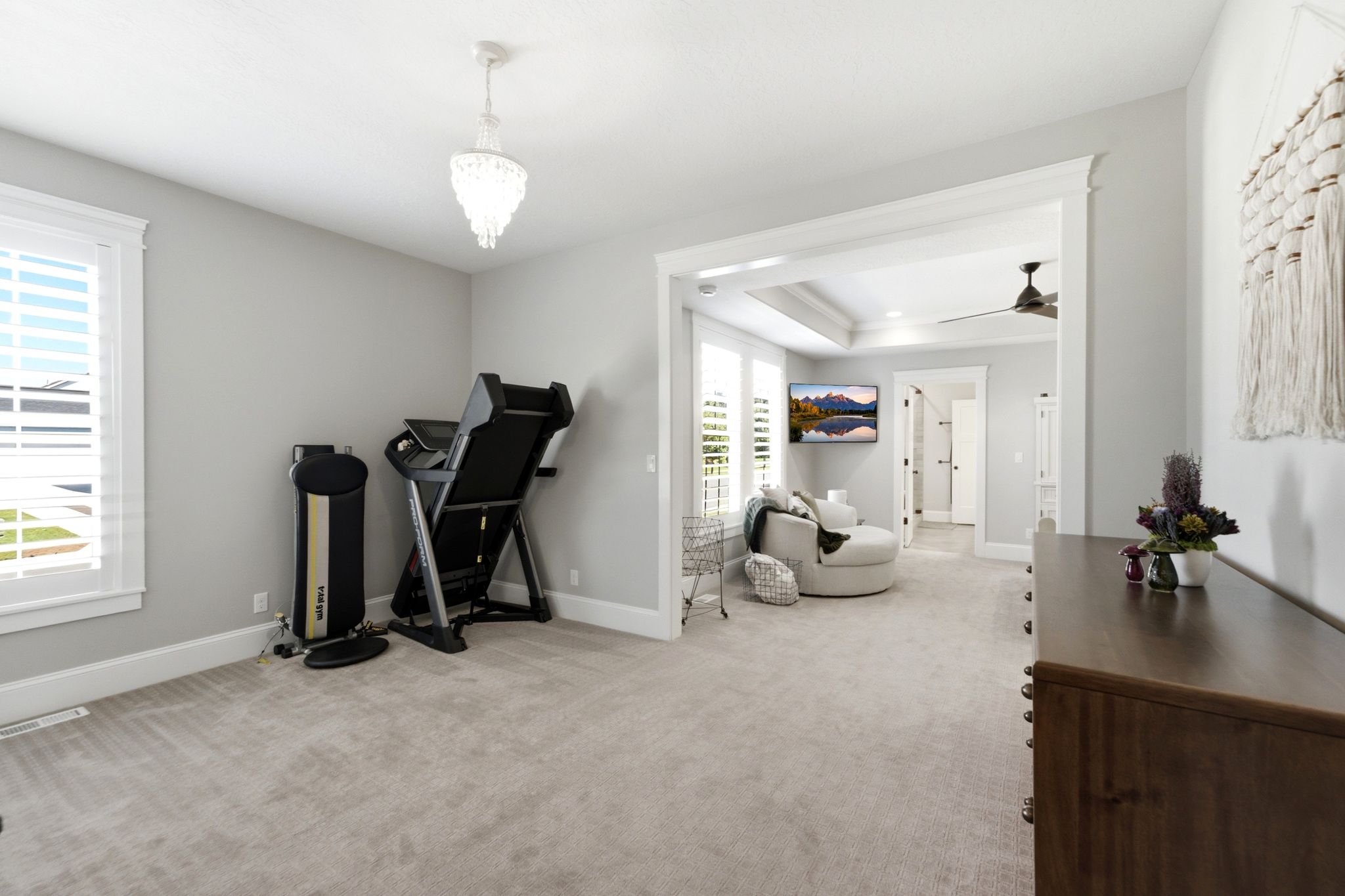Spacious primary suite features plantation shutters