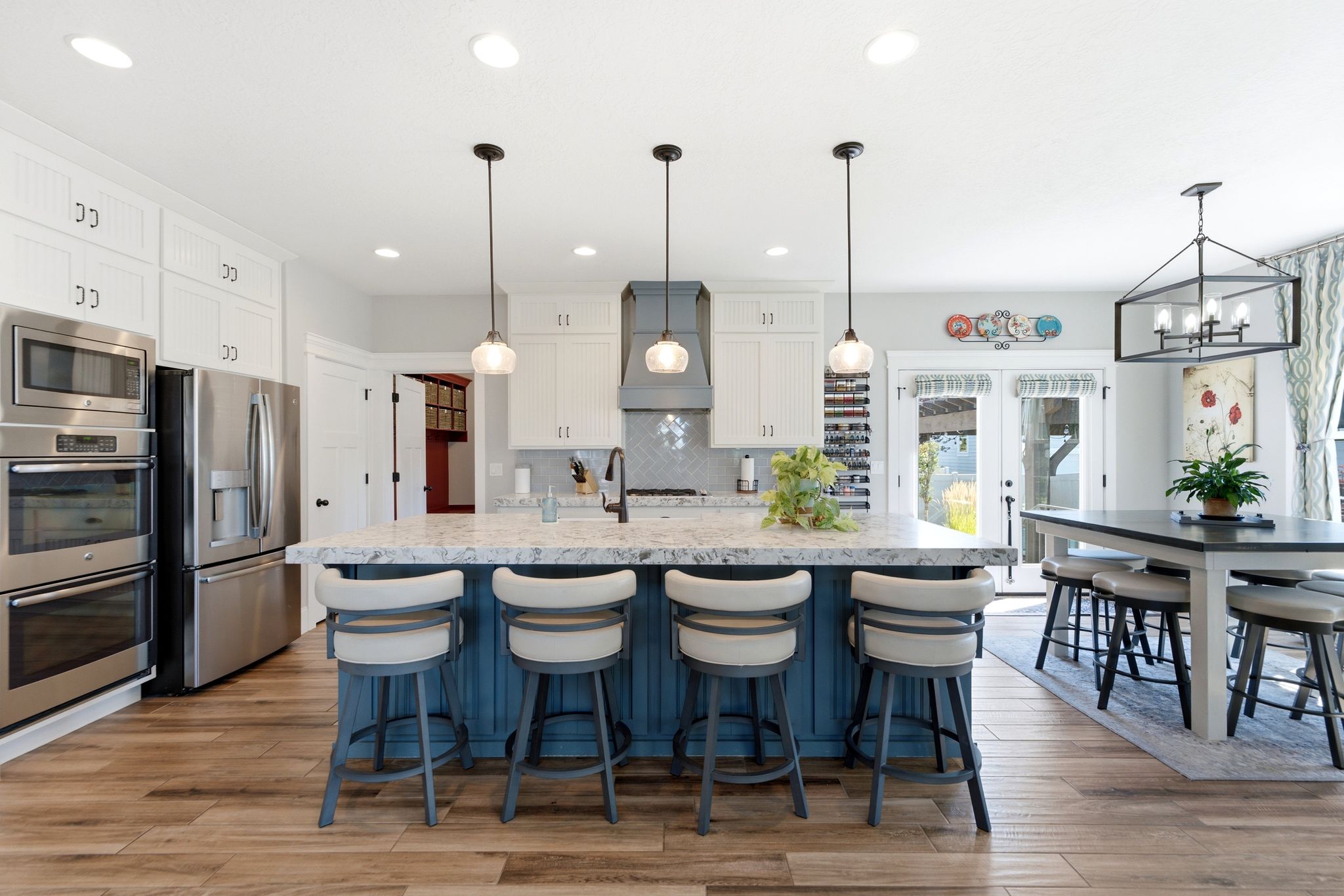 Open kitchen with bar seating and semi-formal dining