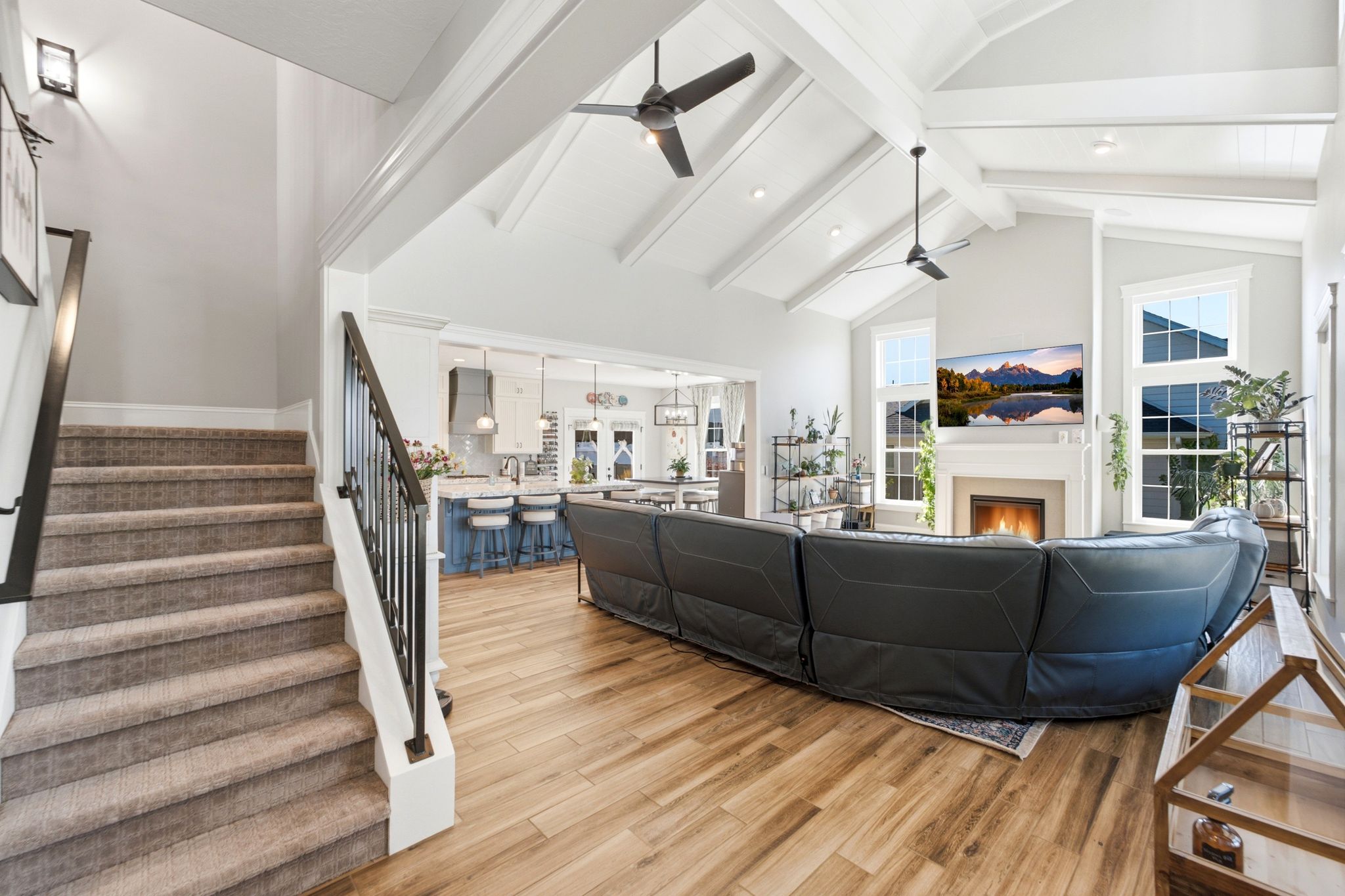 Great room-view of stairs going up and kitchen