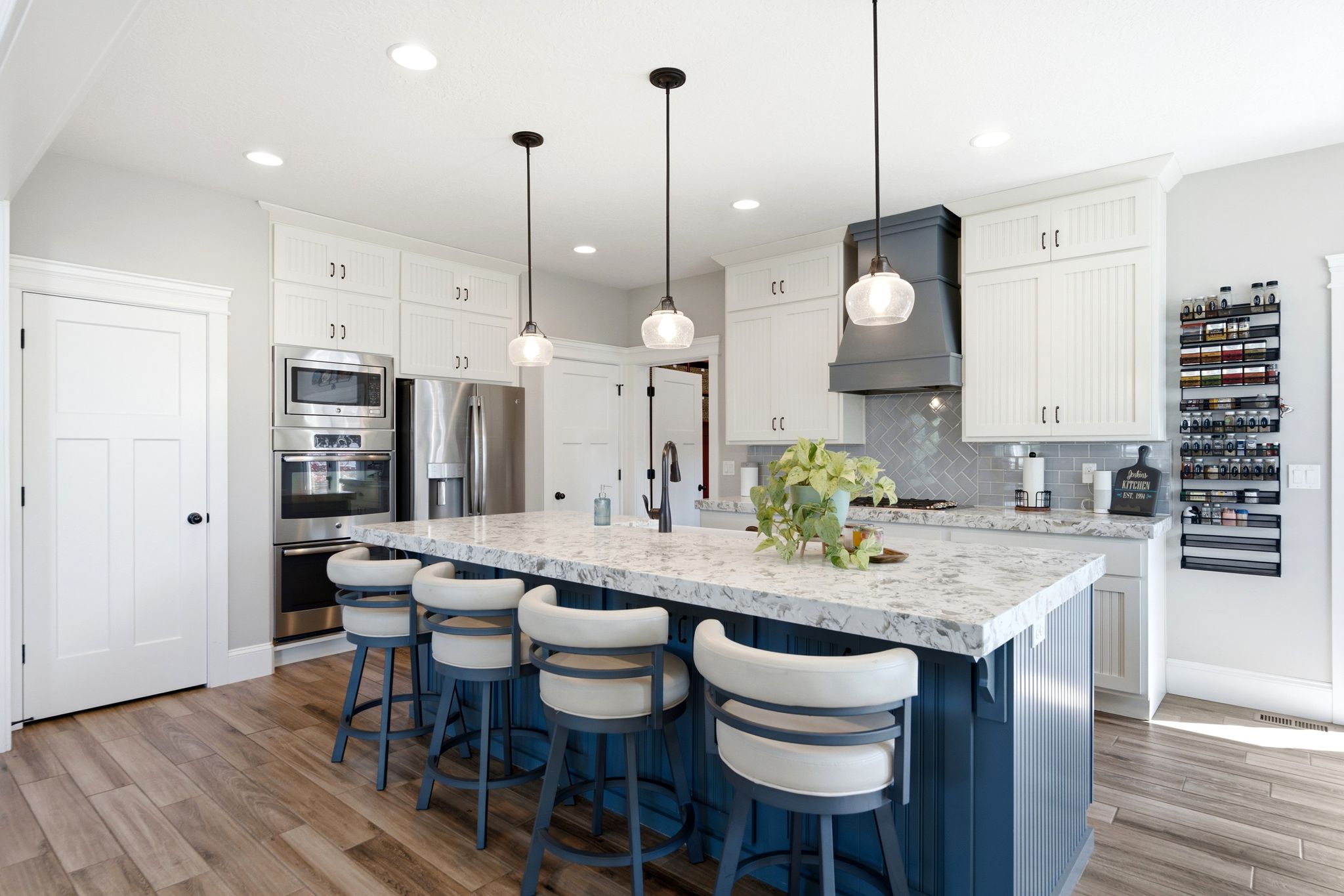 Kitchen showing 2 pantries, double oven, refrigerator and microwave