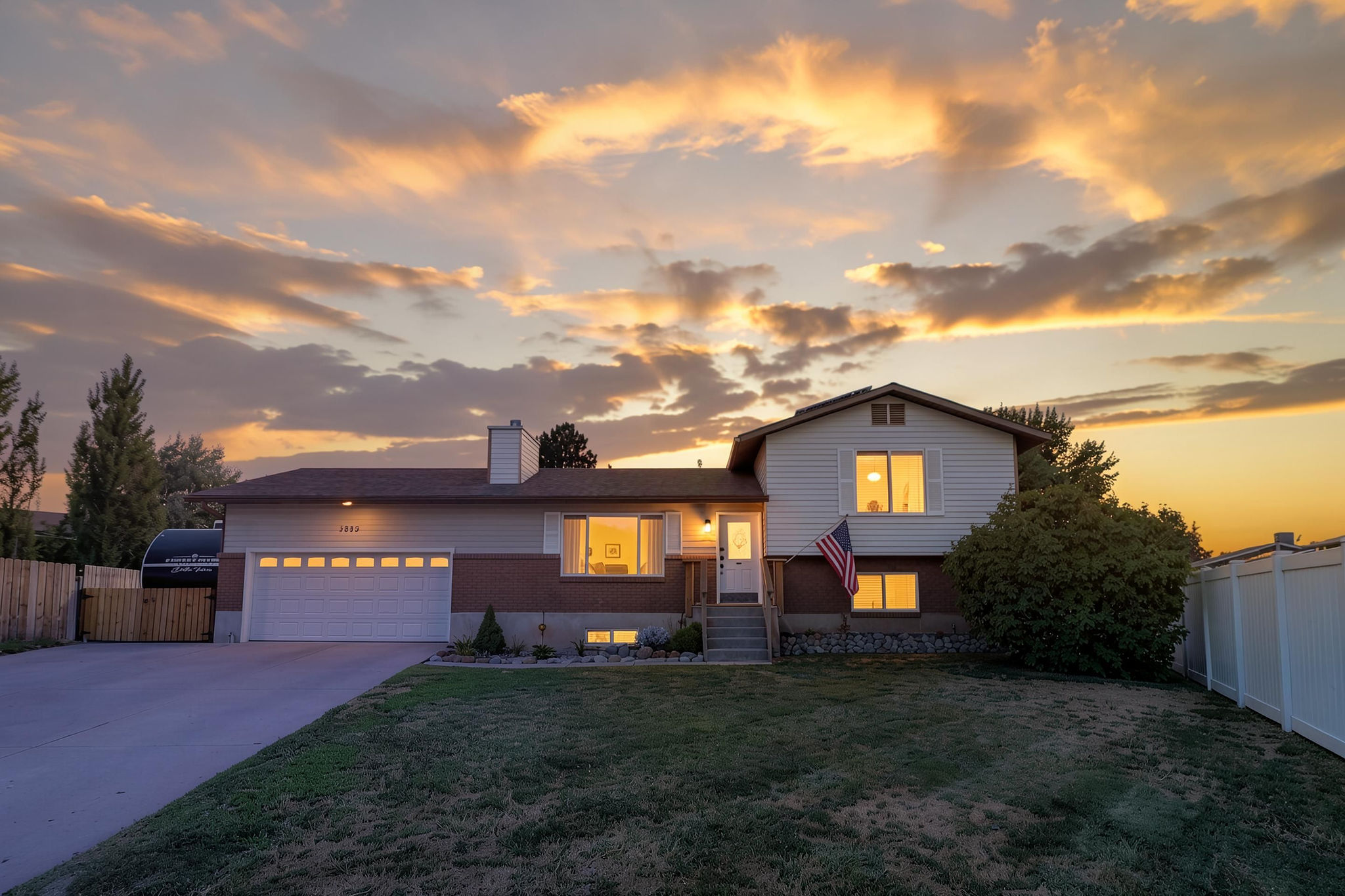 Split-level residence featuring a brick and siding exterior