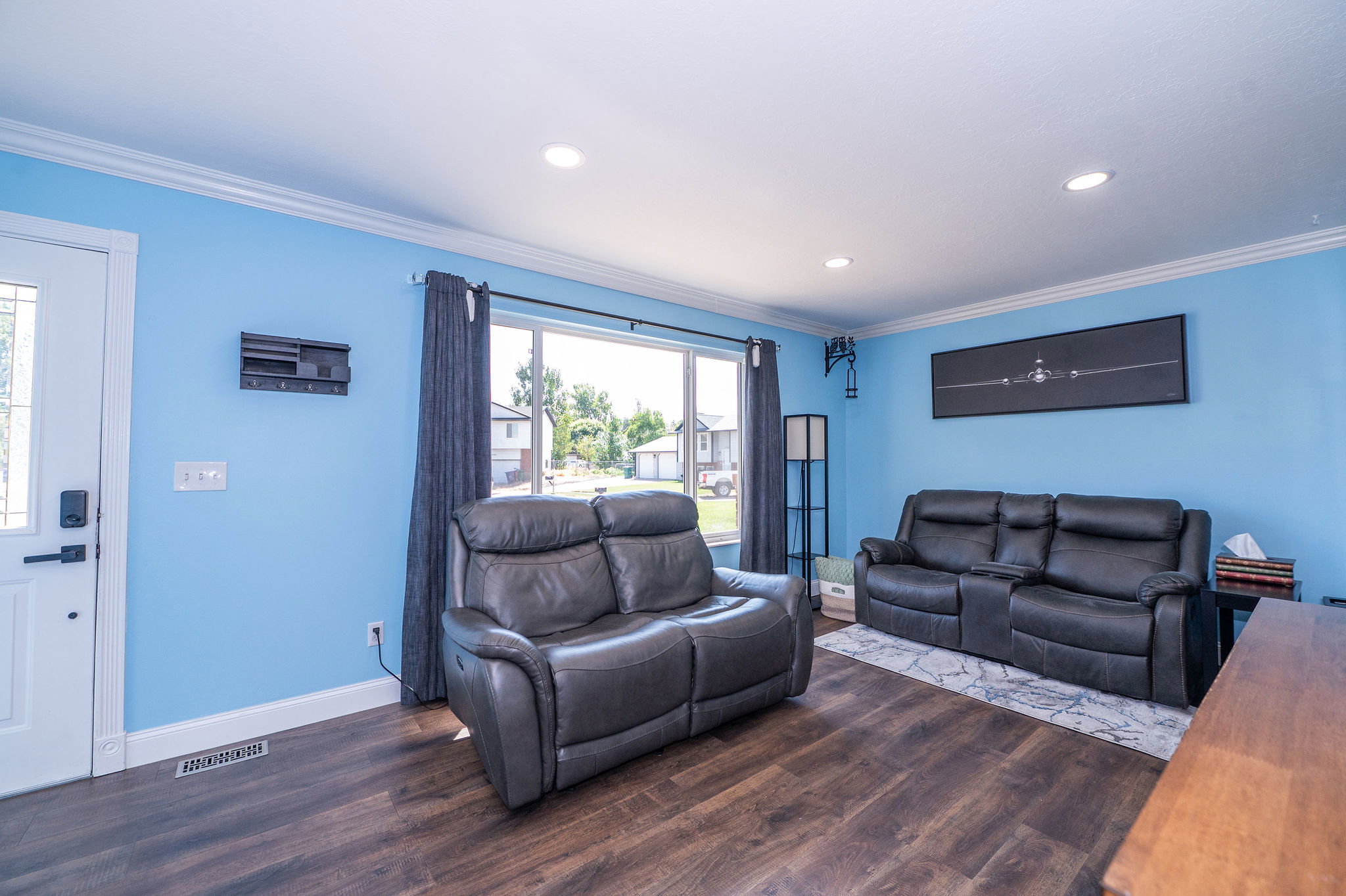 Bright interior with wood-finish flooring, recessed lighting, and white crown molding