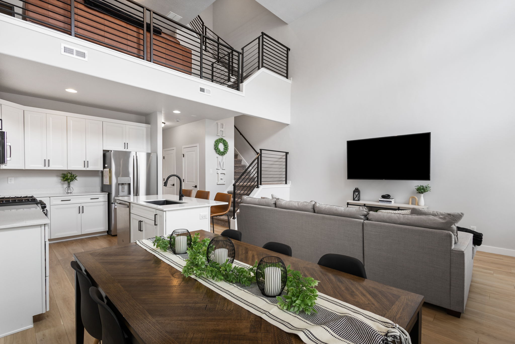 Open-concept living space with light wood-finish flooring