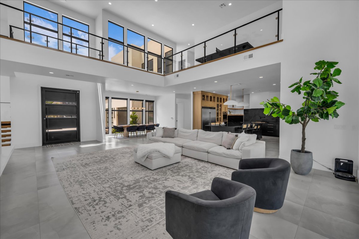 Open-concept living space featuring high ceilings and expansive windows