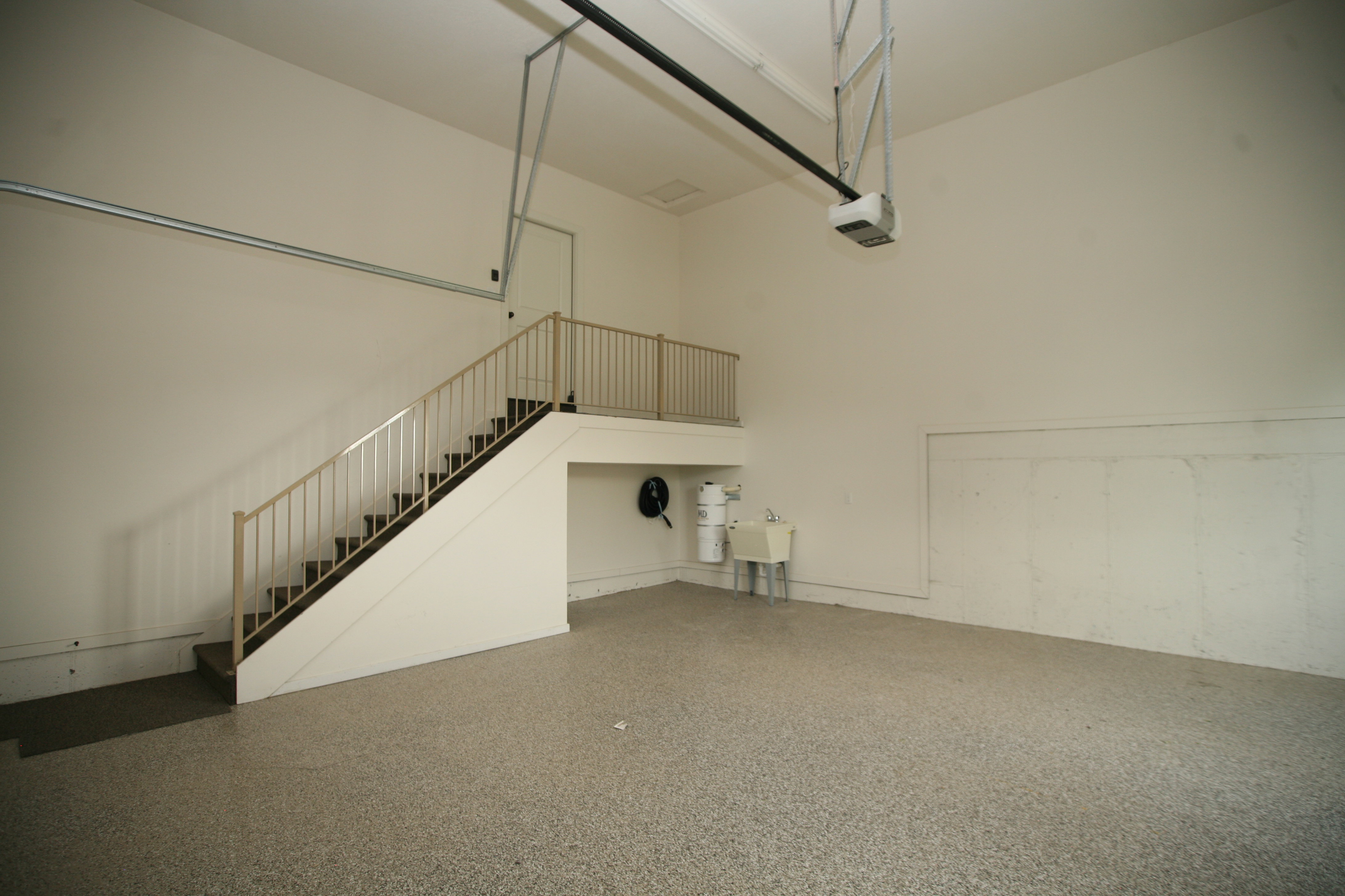 Spacious garage featuring high ceilings, epoxy flooring, built-in utility sink. You will love this home it has two garages, both are painted tall ceilings, epoxy floors and Insulated garage doors.