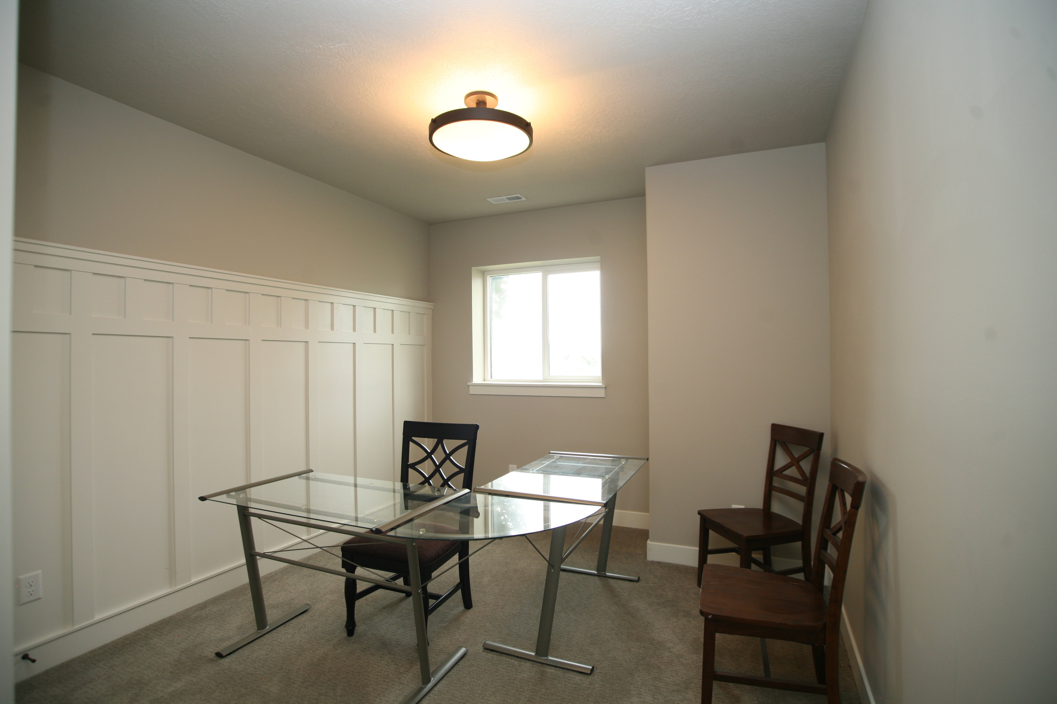 Room featuring white board and batten wall paneling, great for office or bedroom.