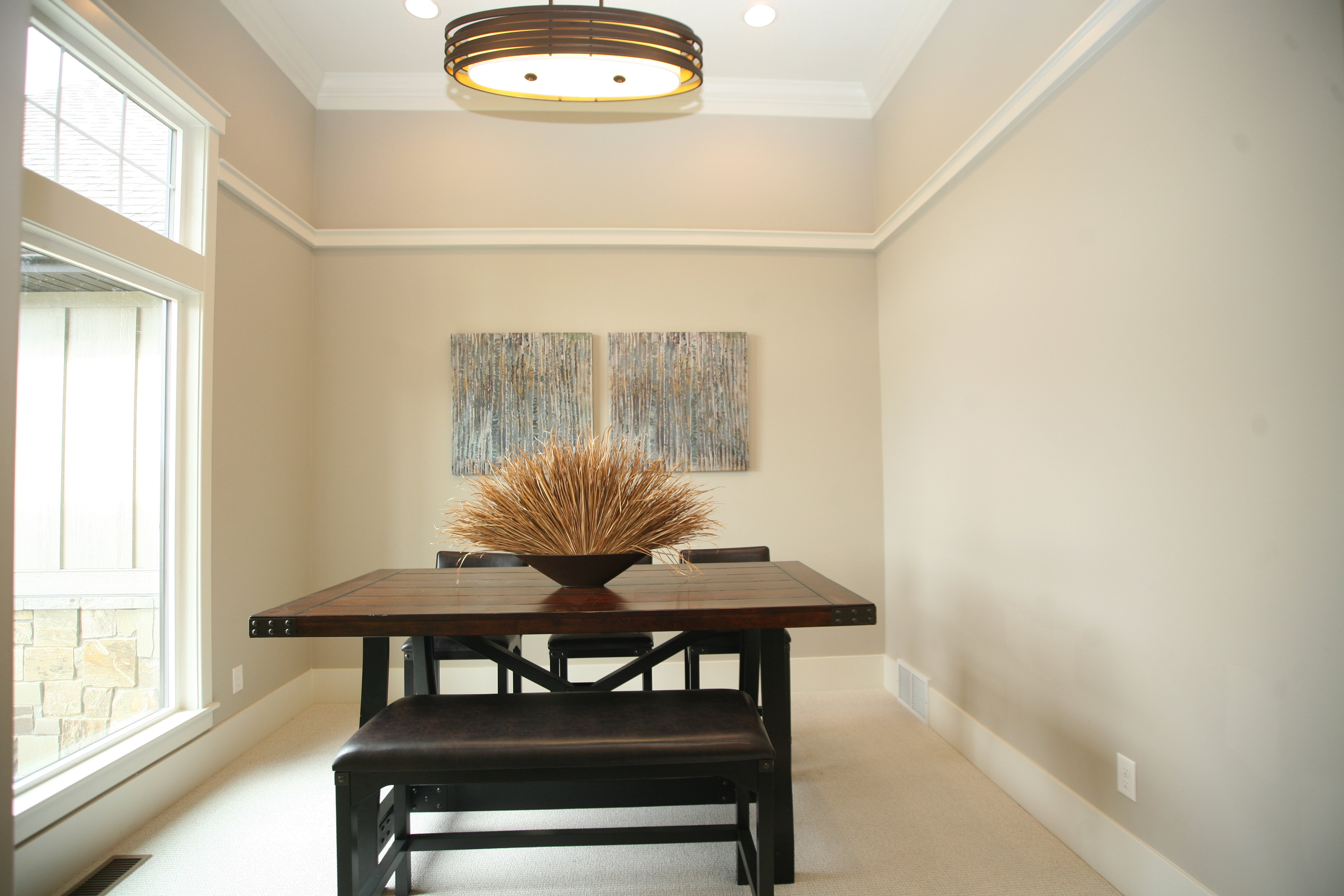 Living room, sitting room, music room, dining area , this is great flex spacefeaturing neutral wall tones, crown molding, and a substantial window with upper transom details