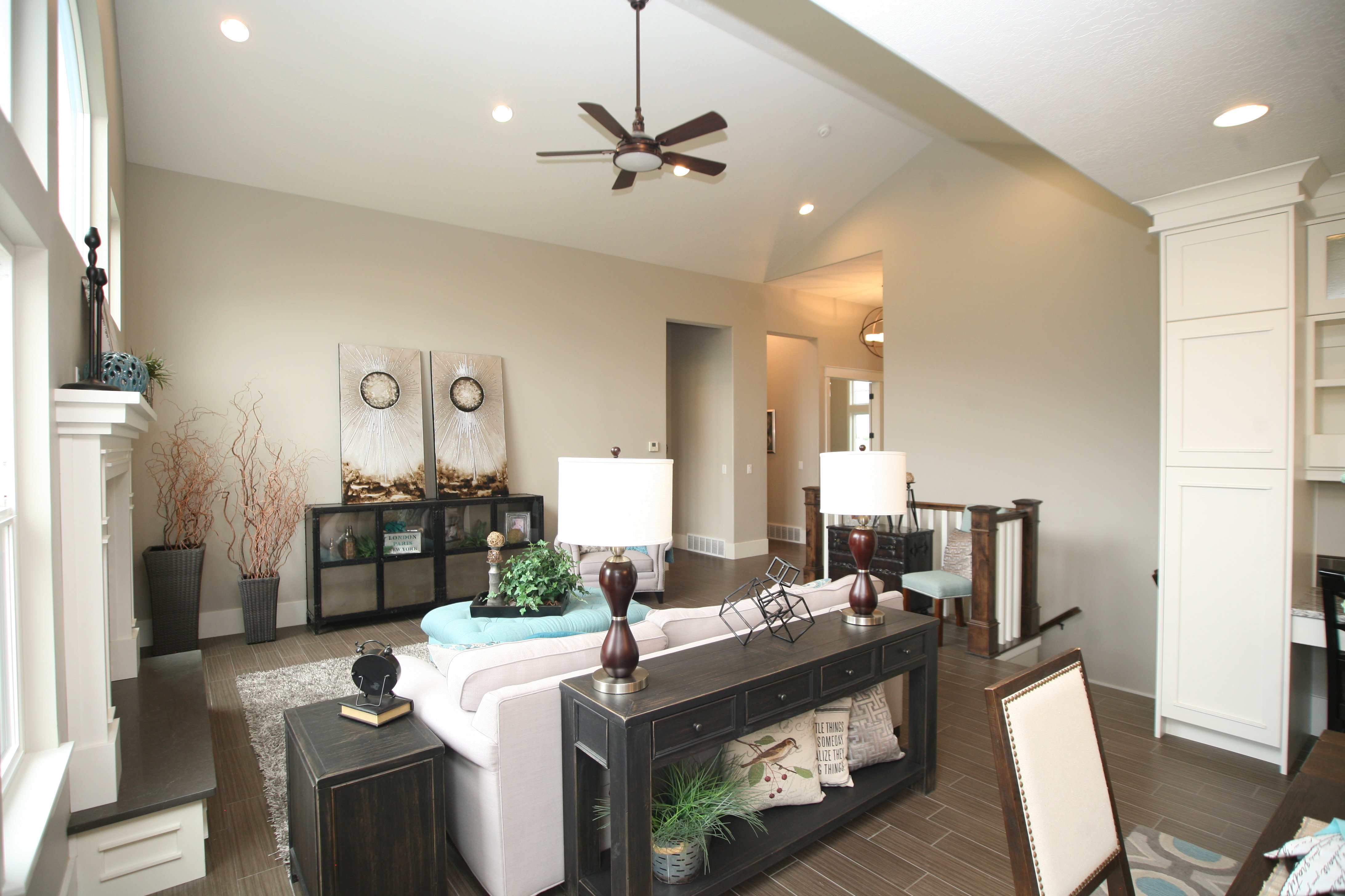 Vaulted ceilings with recessed lighting and a ceiling fan
