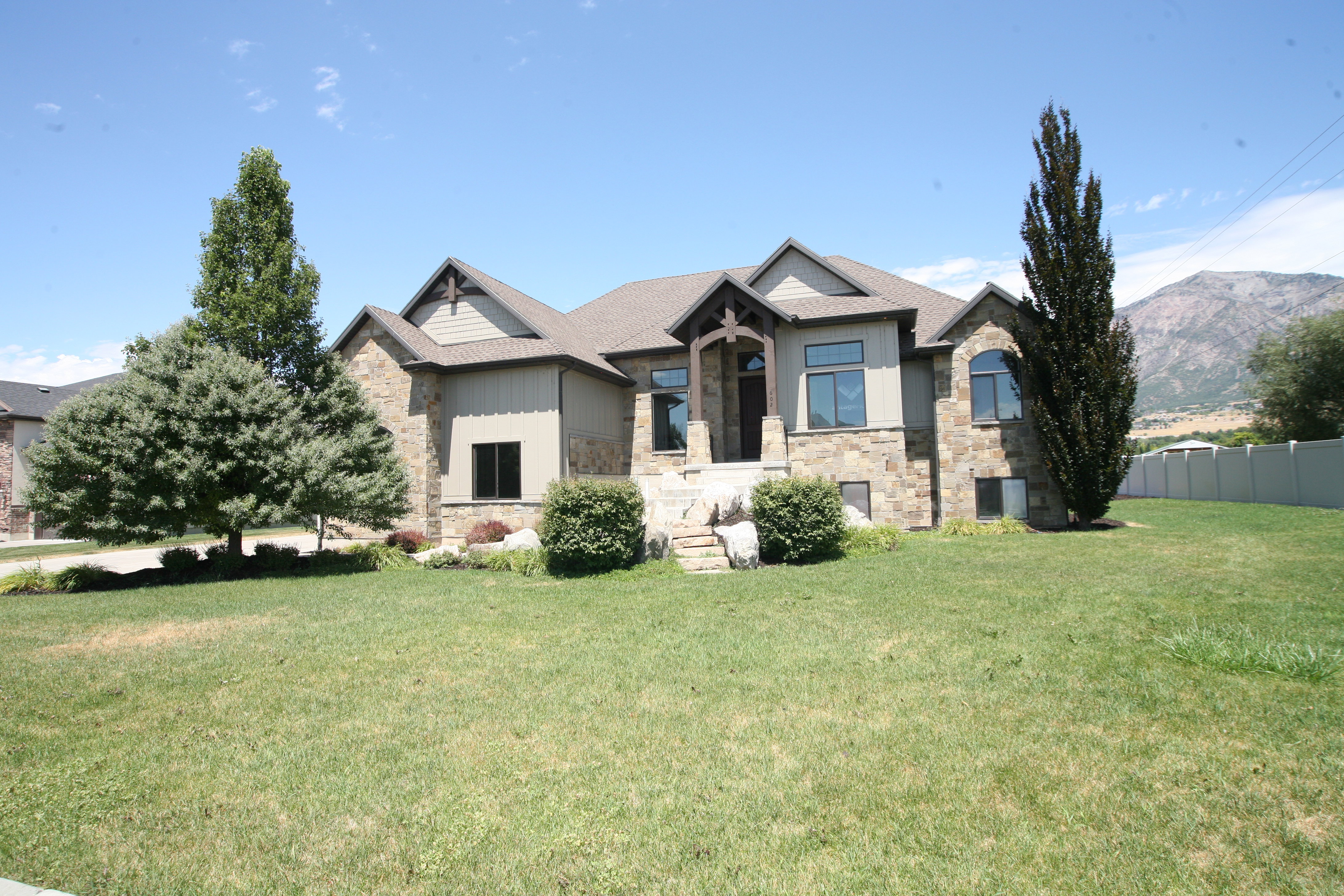Stone and siding exterior with gabled roof lines