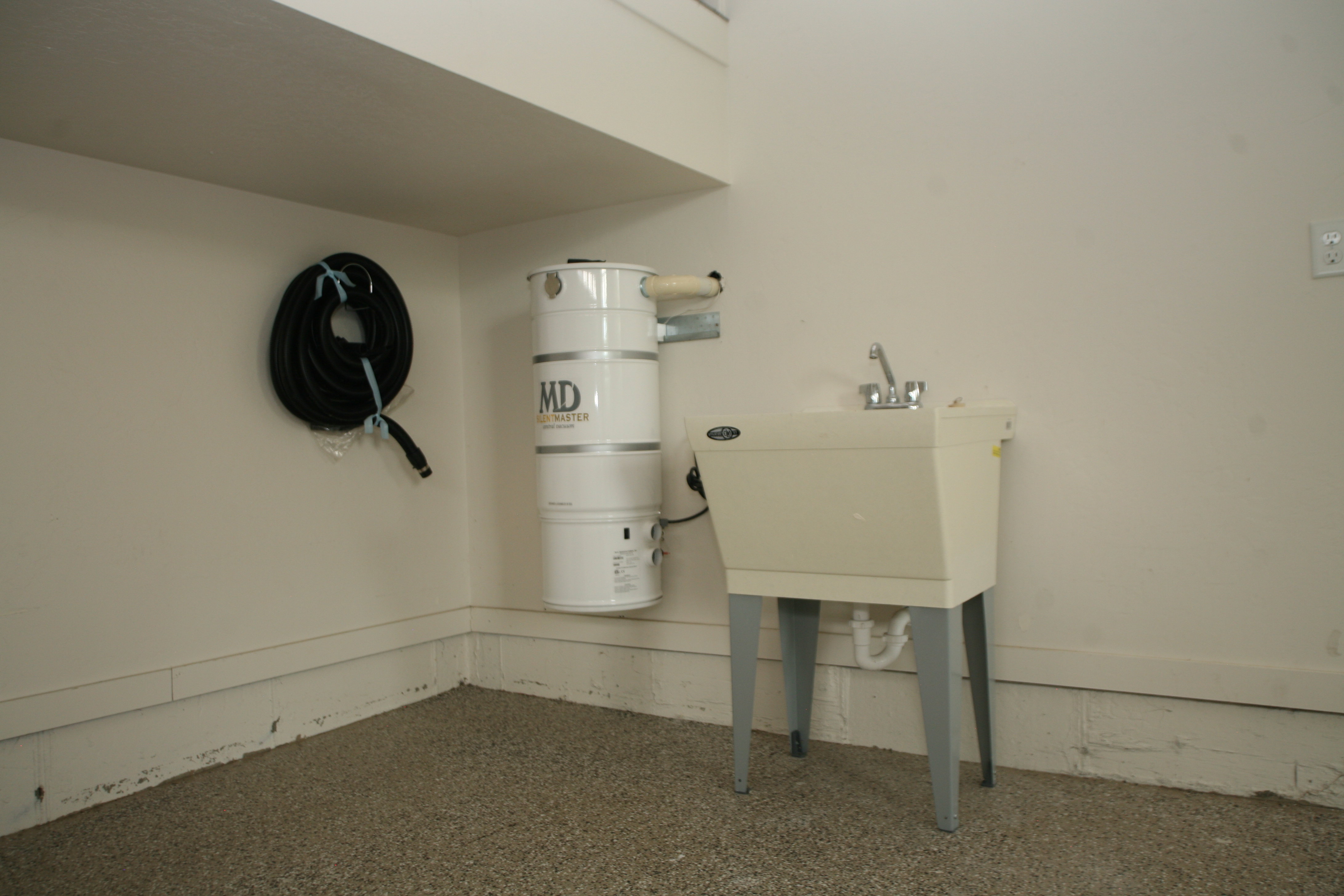 Utility sink with chrome faucet and central vacuum system, main garage off home.