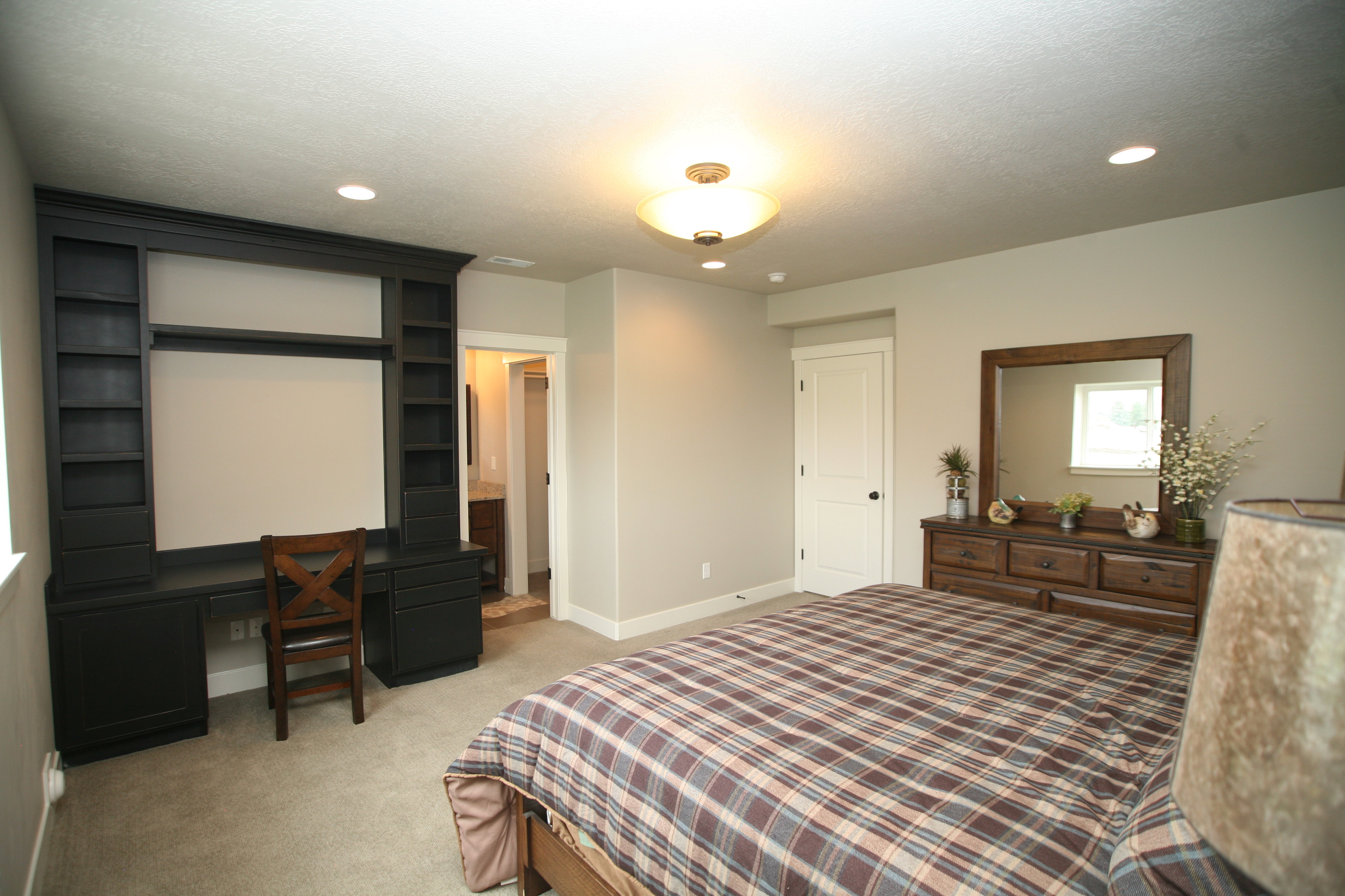 Built-in desk unit with integrated shelving, recessed lighting, and neutral wall paint