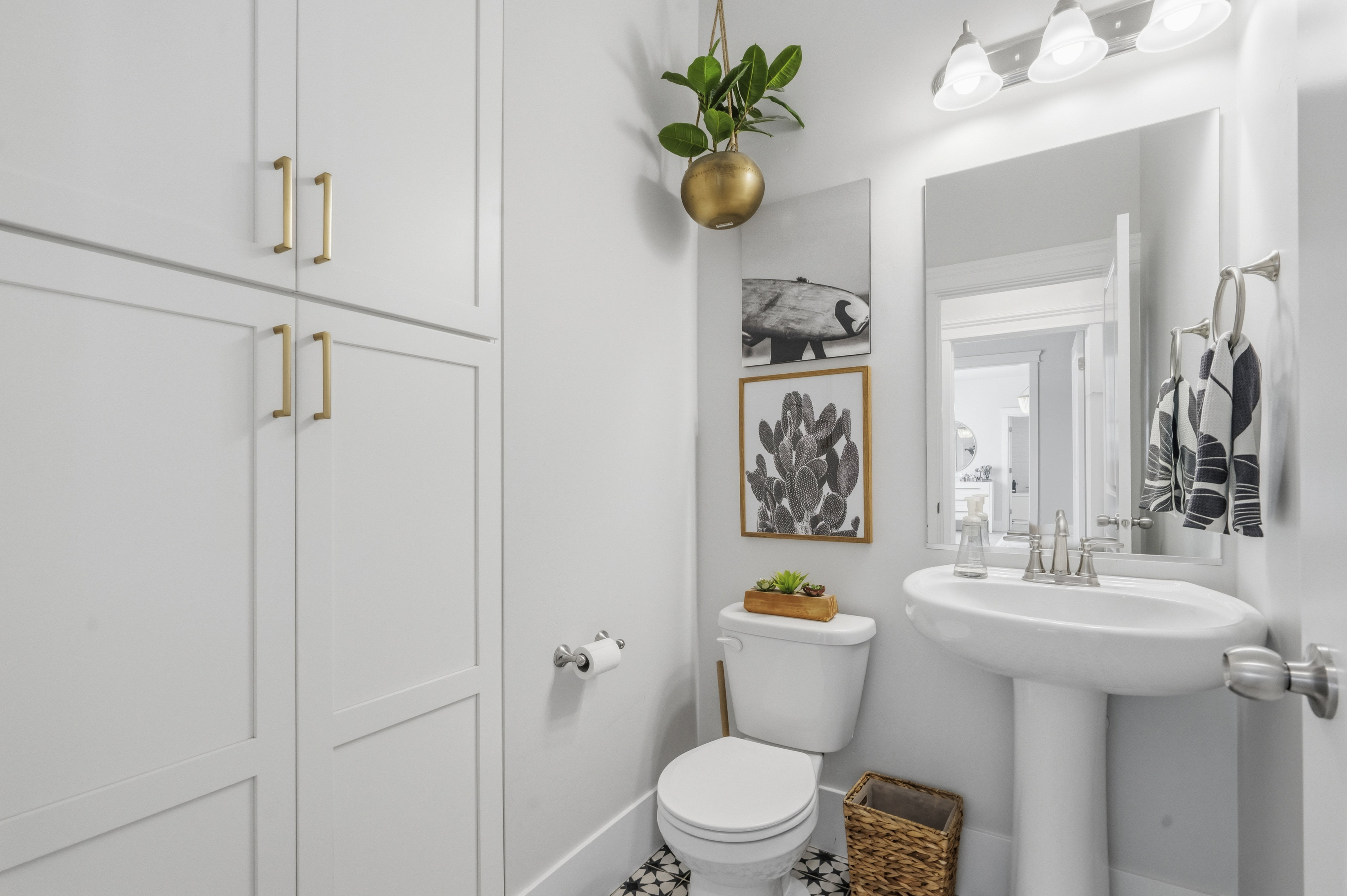 White pedestal sink with a contemporary faucet and mirror