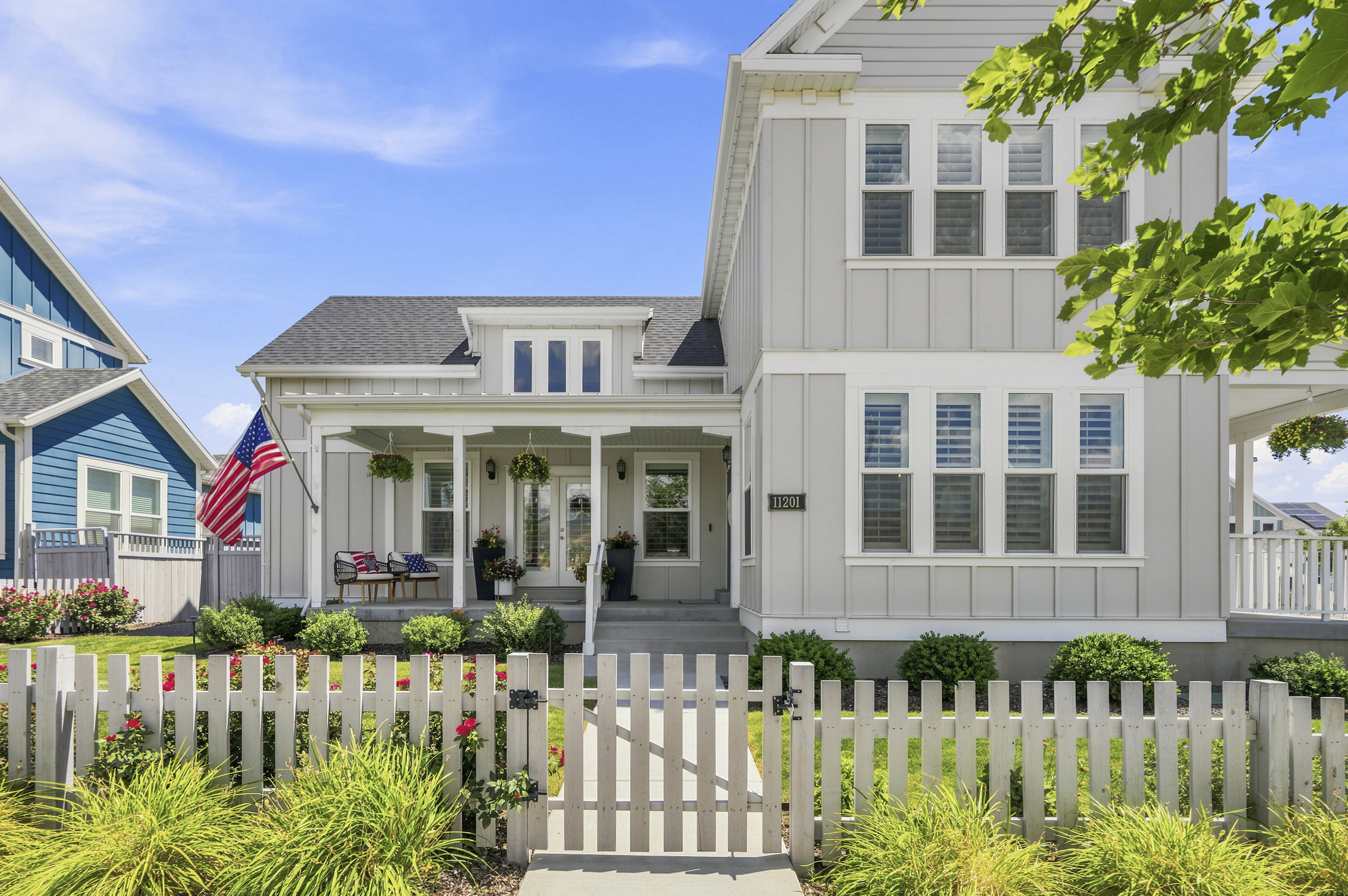 Light gray board-and-batten siding with white trim