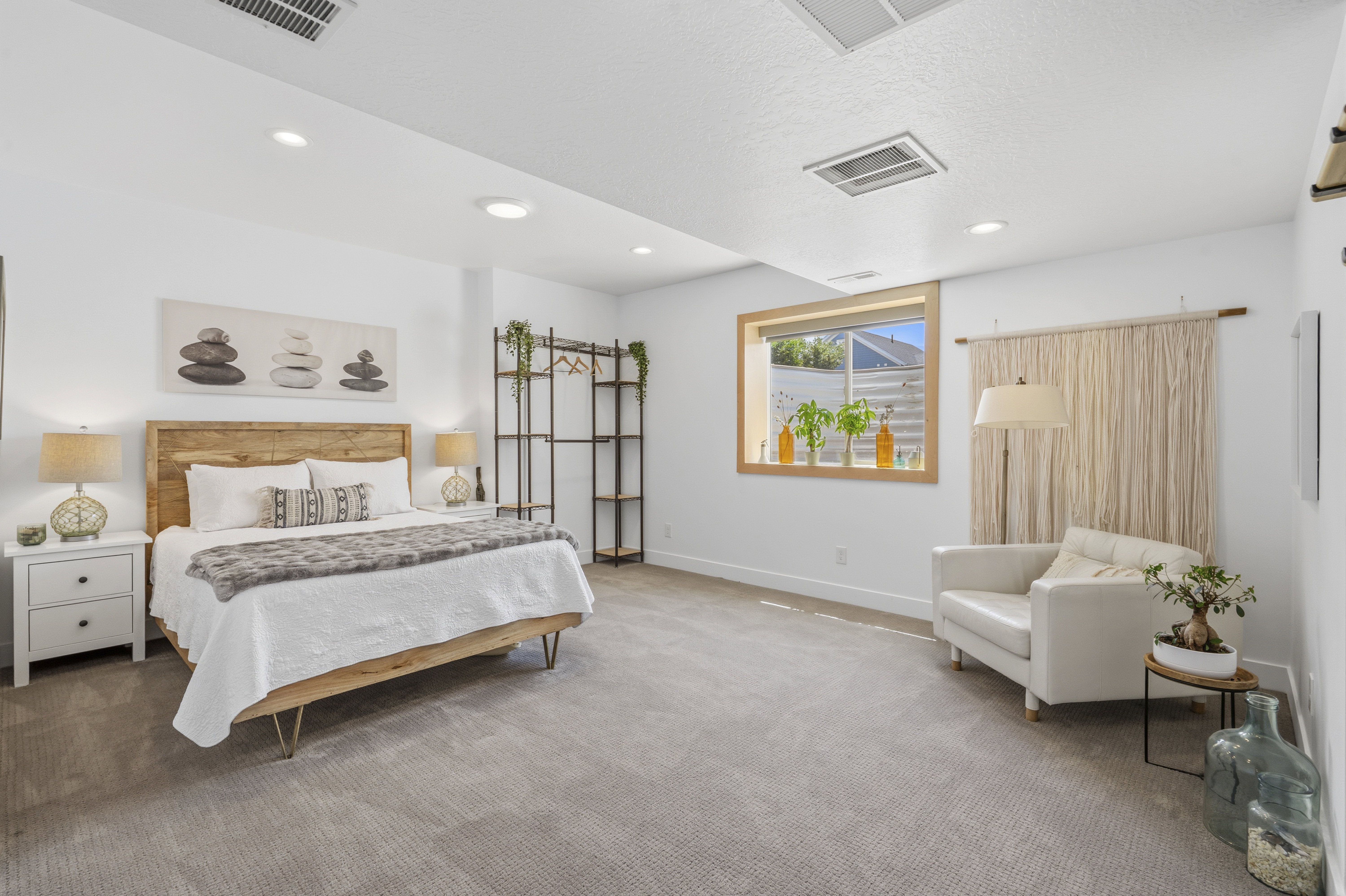 Carpeted bedroom with recessed lighting and a wood-framed window