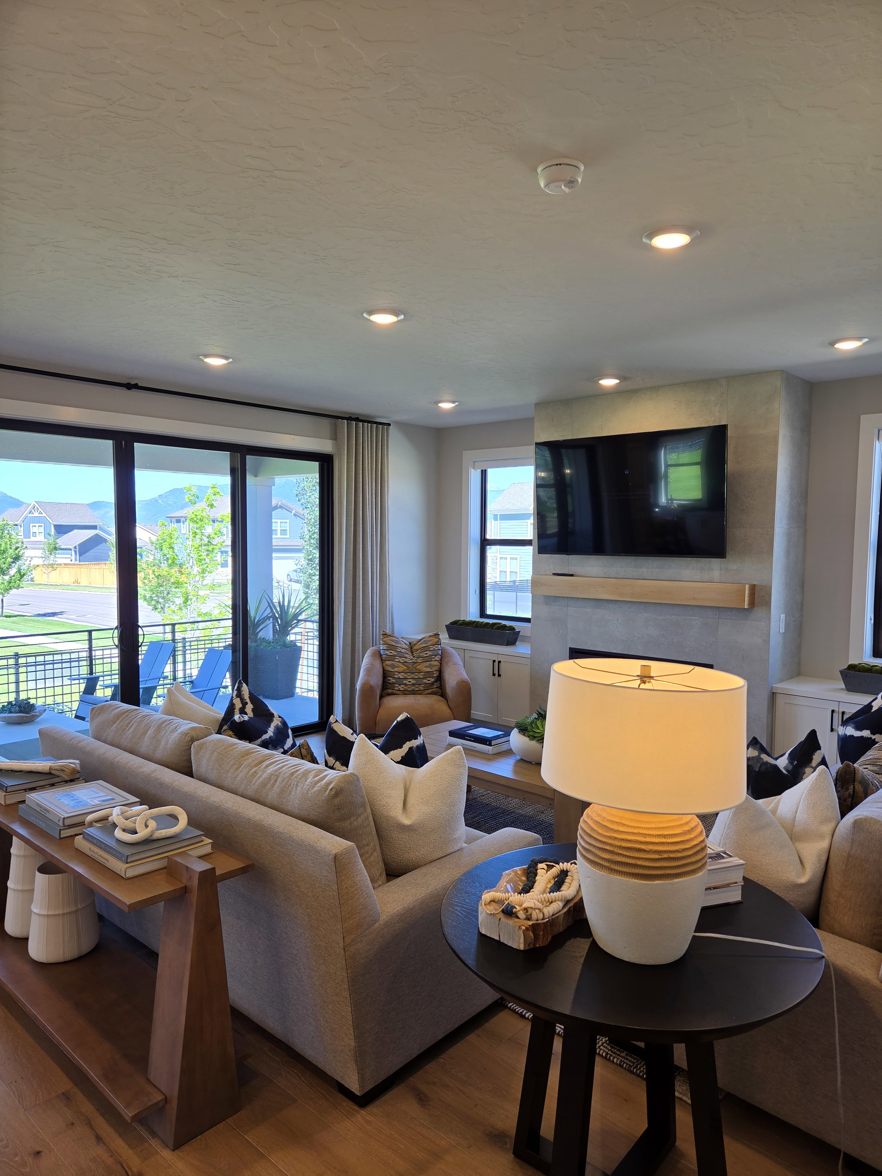 Spacious living area featuring expansive sliding glass doors opening to a balcony