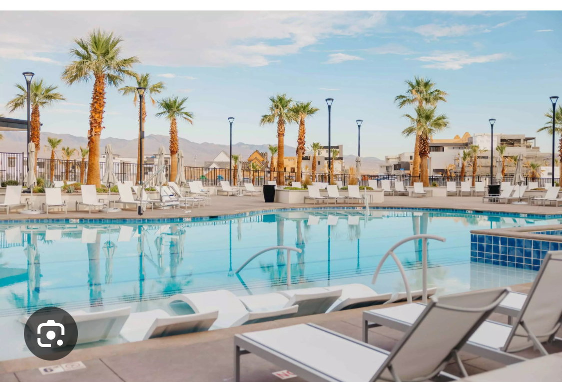 Expansive community pool area featuring a large, clear blue Lagoon  2.5 acre  swimming pool with integrated sun loungers Bring your paddleboards , Kayaks