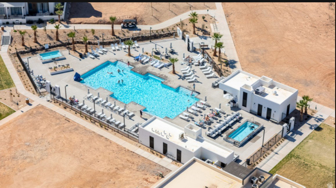 Resort-style pool area featuring a large swimming pool, separate rectangular plunge pool, and a dedicated spa