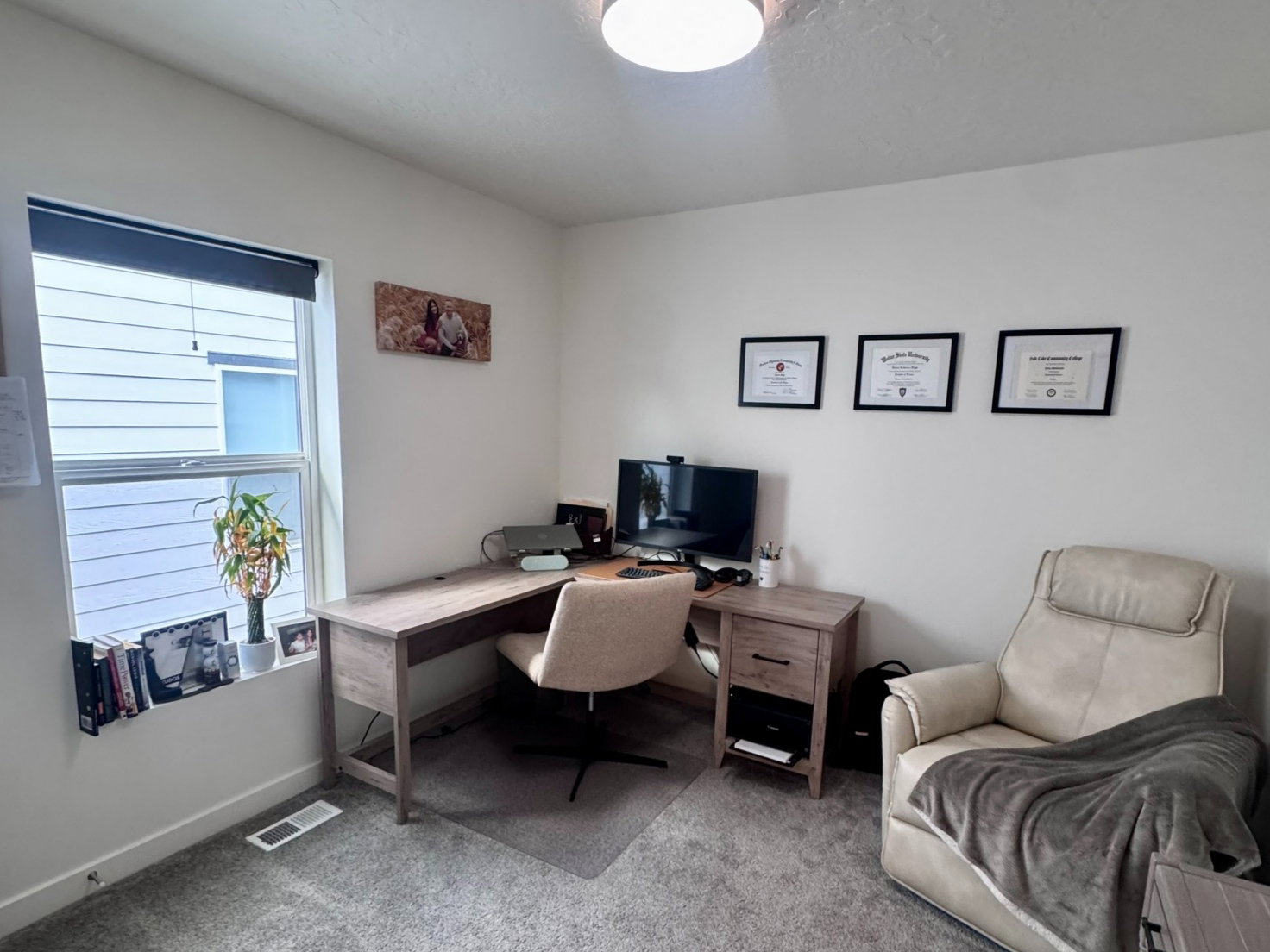 Carpeted room featuring a light-colored wall finish, a window with blinds, and a flush-mount ceiling light fixture