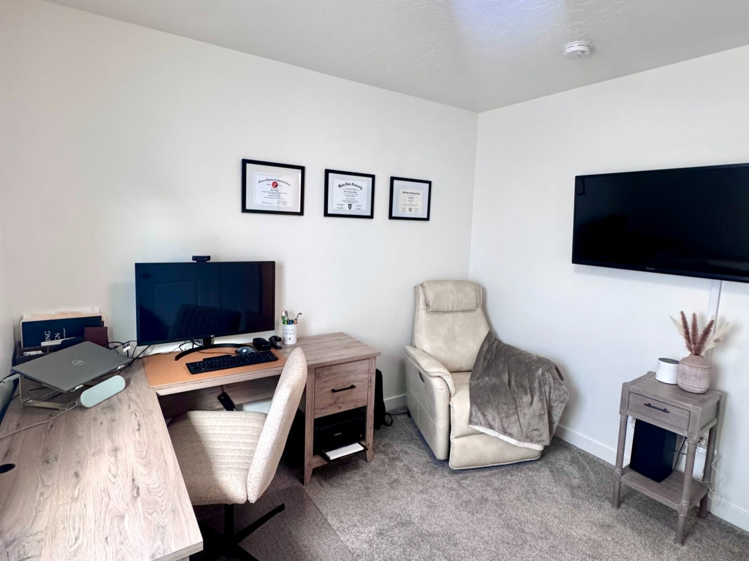 Neutral-toned wall-to-wall carpeting complements the white walls and ceiling