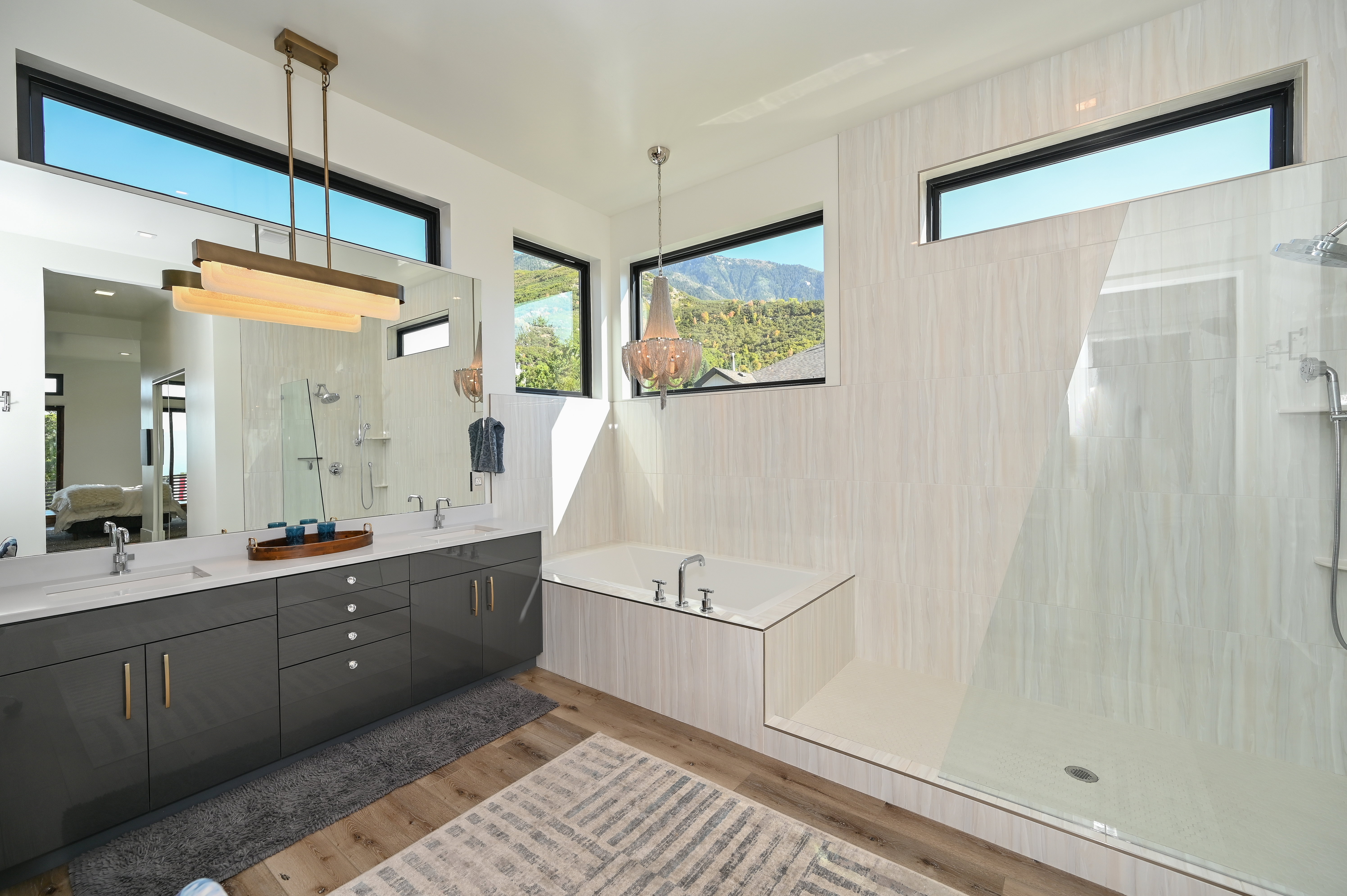 Contemporary bathroom featuring a floating dual vanity with gray cabinetry and white countertops