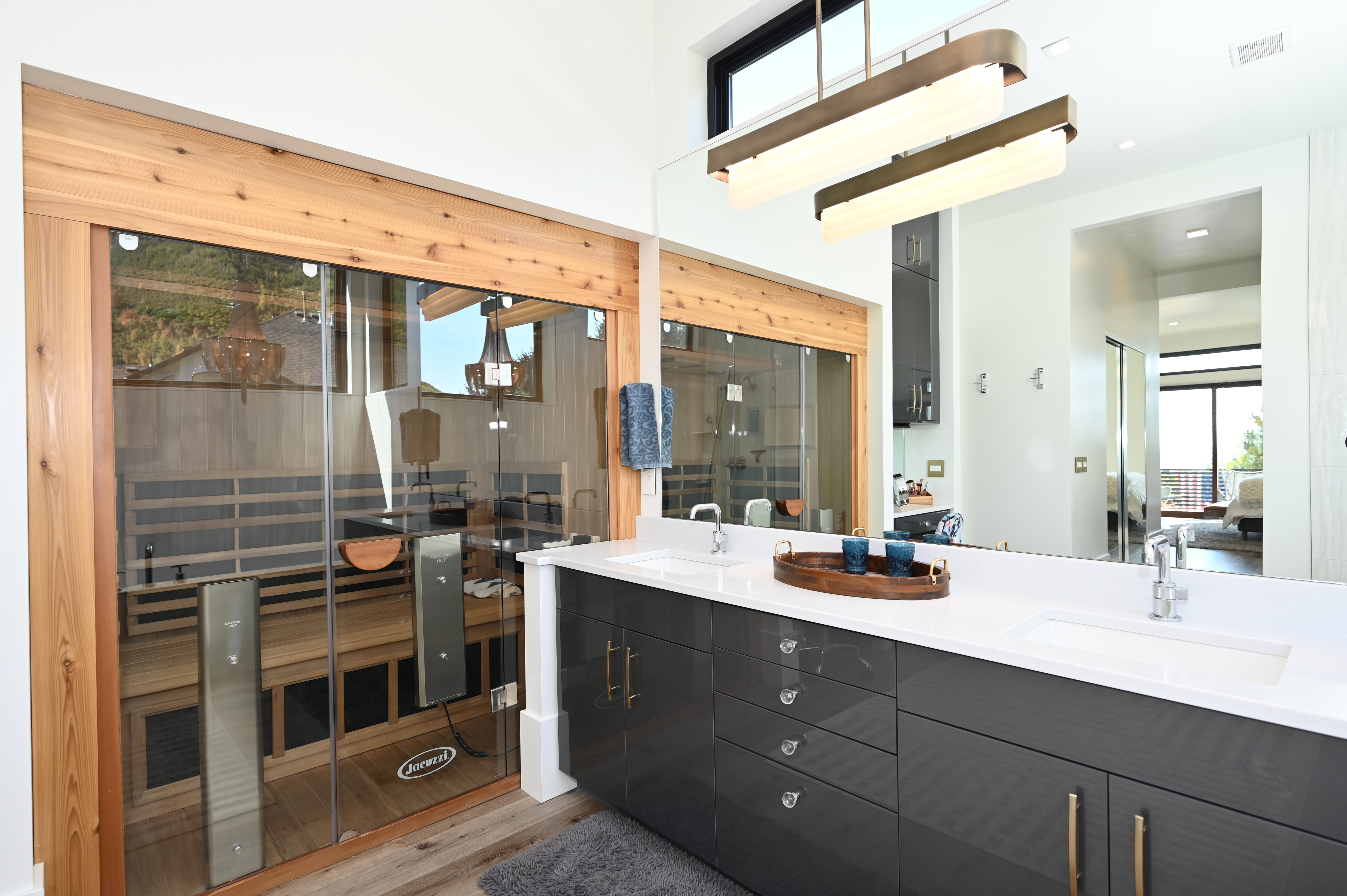 Contemporary bathroom featuring a built-in sauna with a glass enclosure and wood interior