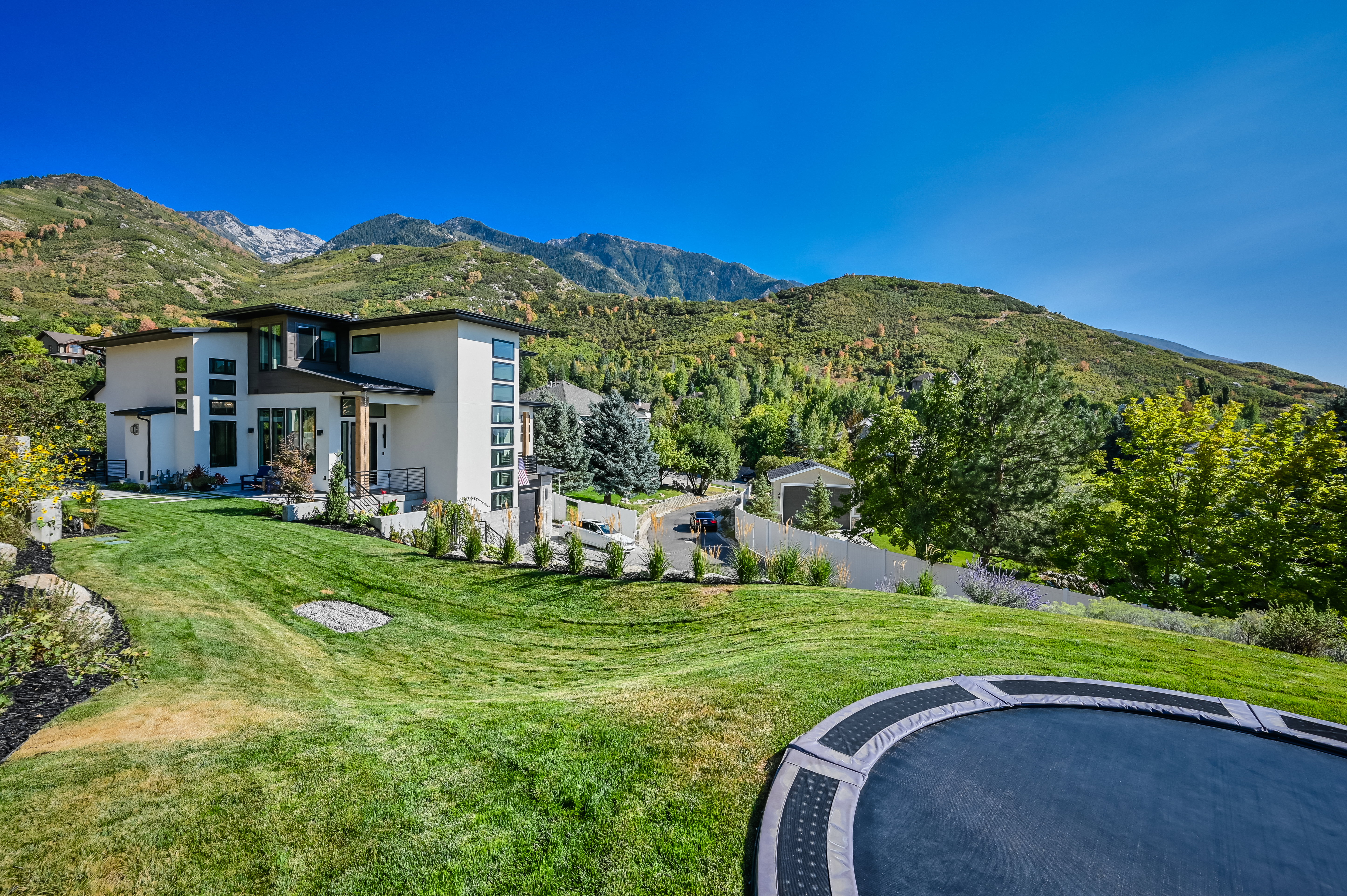 Contemporary multi-level residence featuring a flat roofline, extensive window placement, and a light-toned exterior finish