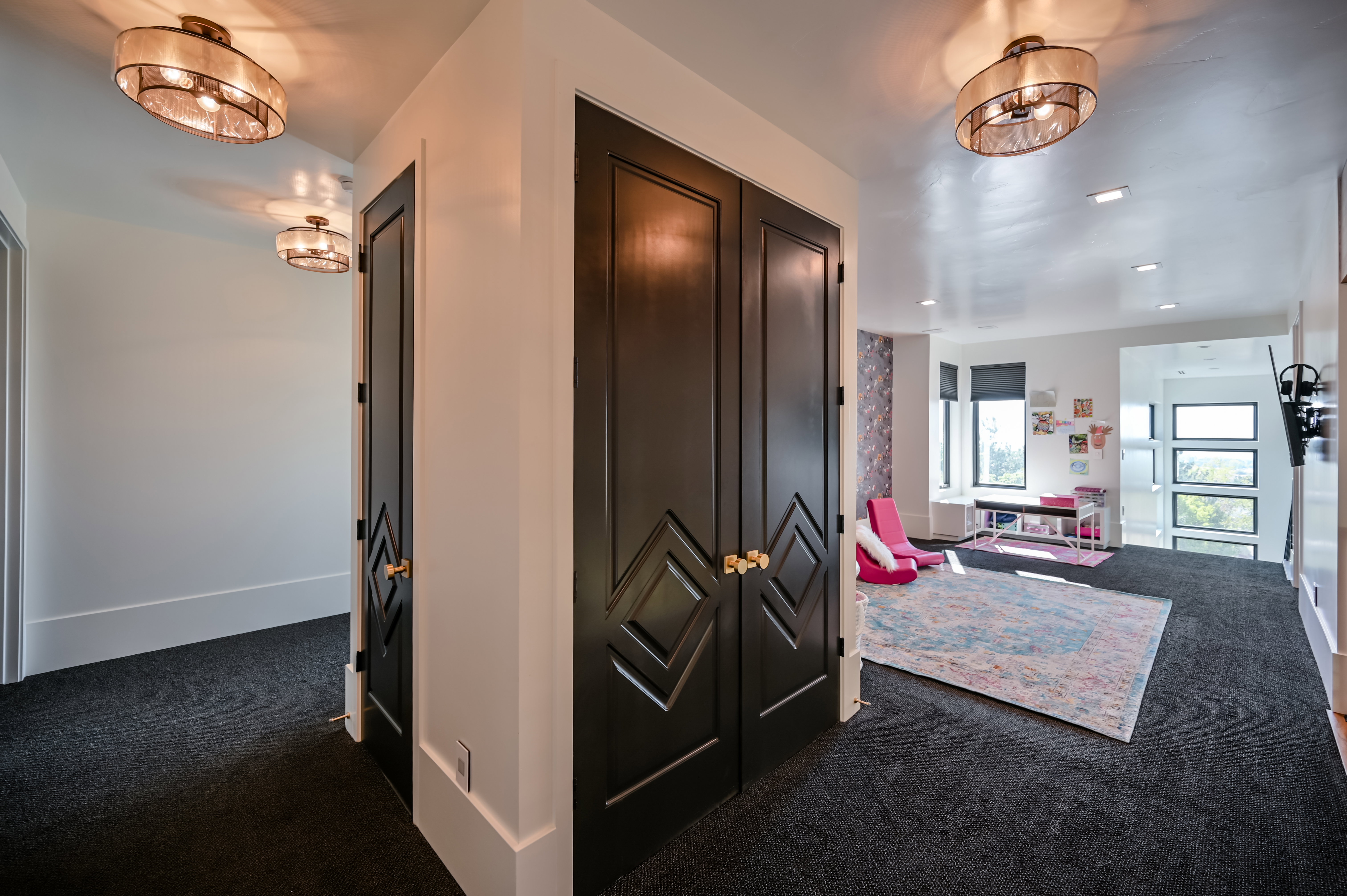 Dark carpeting throughout with white baseboards and walls