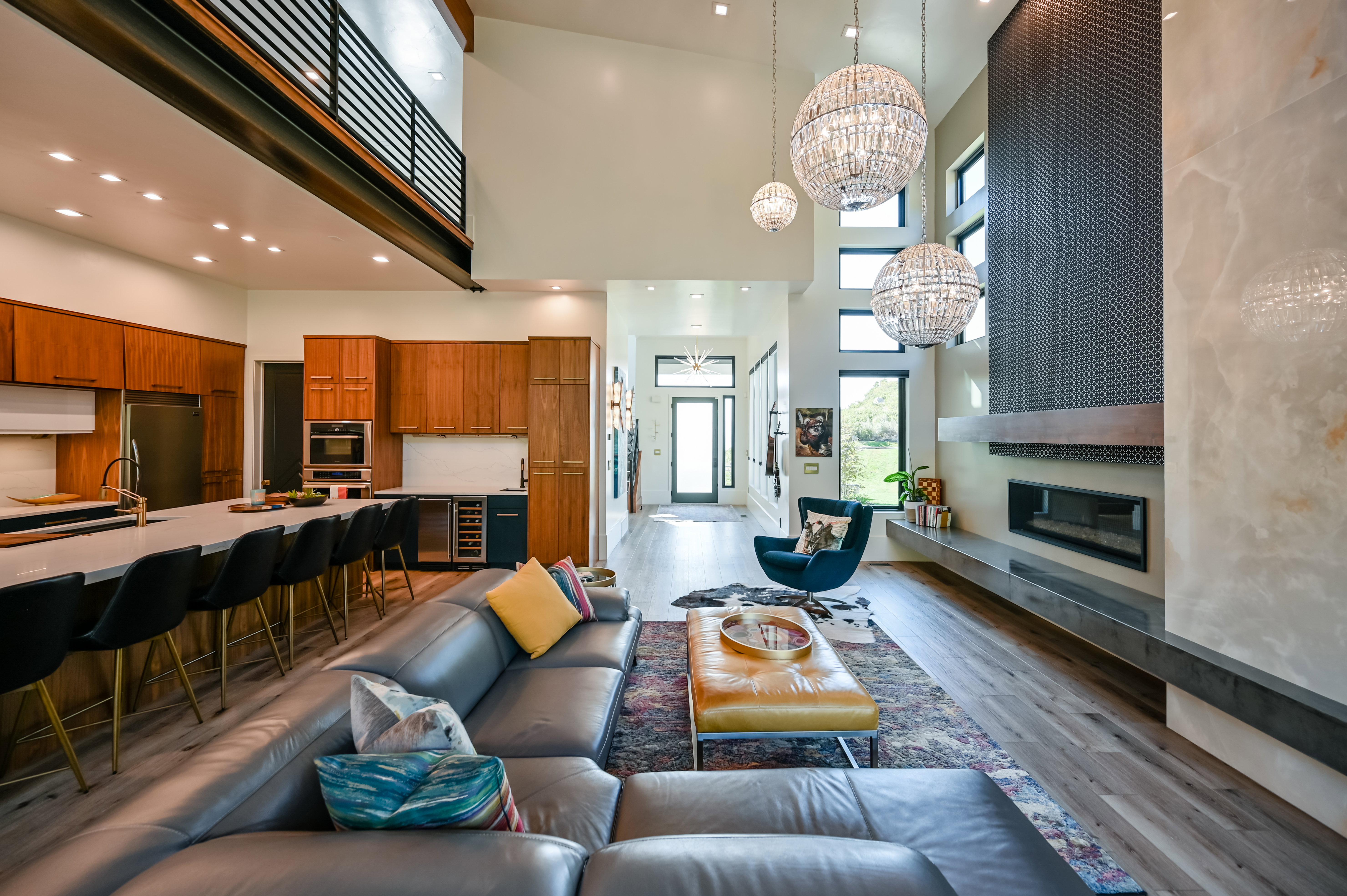 Expansive living area featuring soaring ceilings and wood-finish flooring