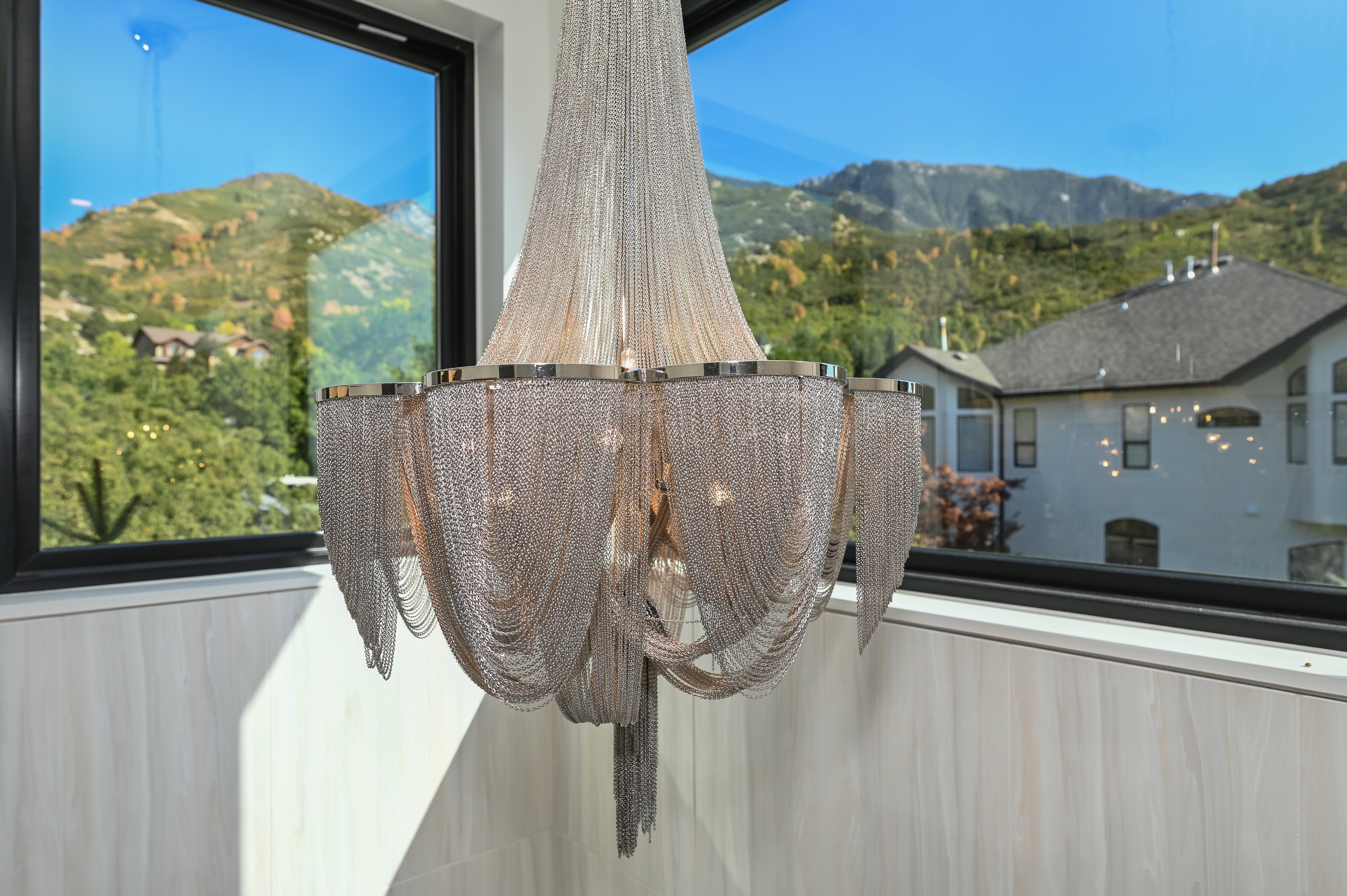 Multi-tiered chainmail chandelier with polished chrome accents