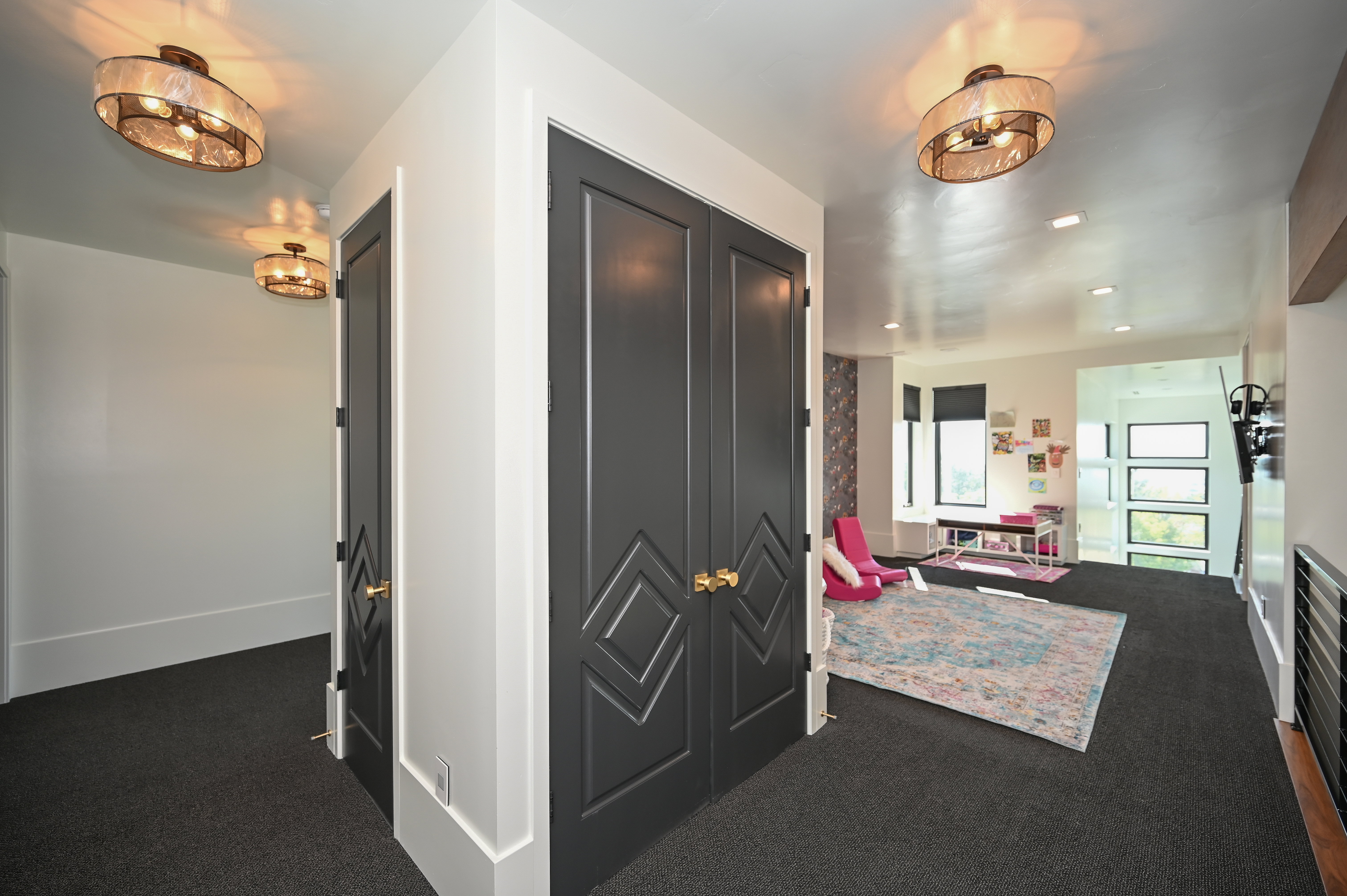 Hallway featuring dark gray carpet flooring, recessed lighting, and modern ceiling fixtures