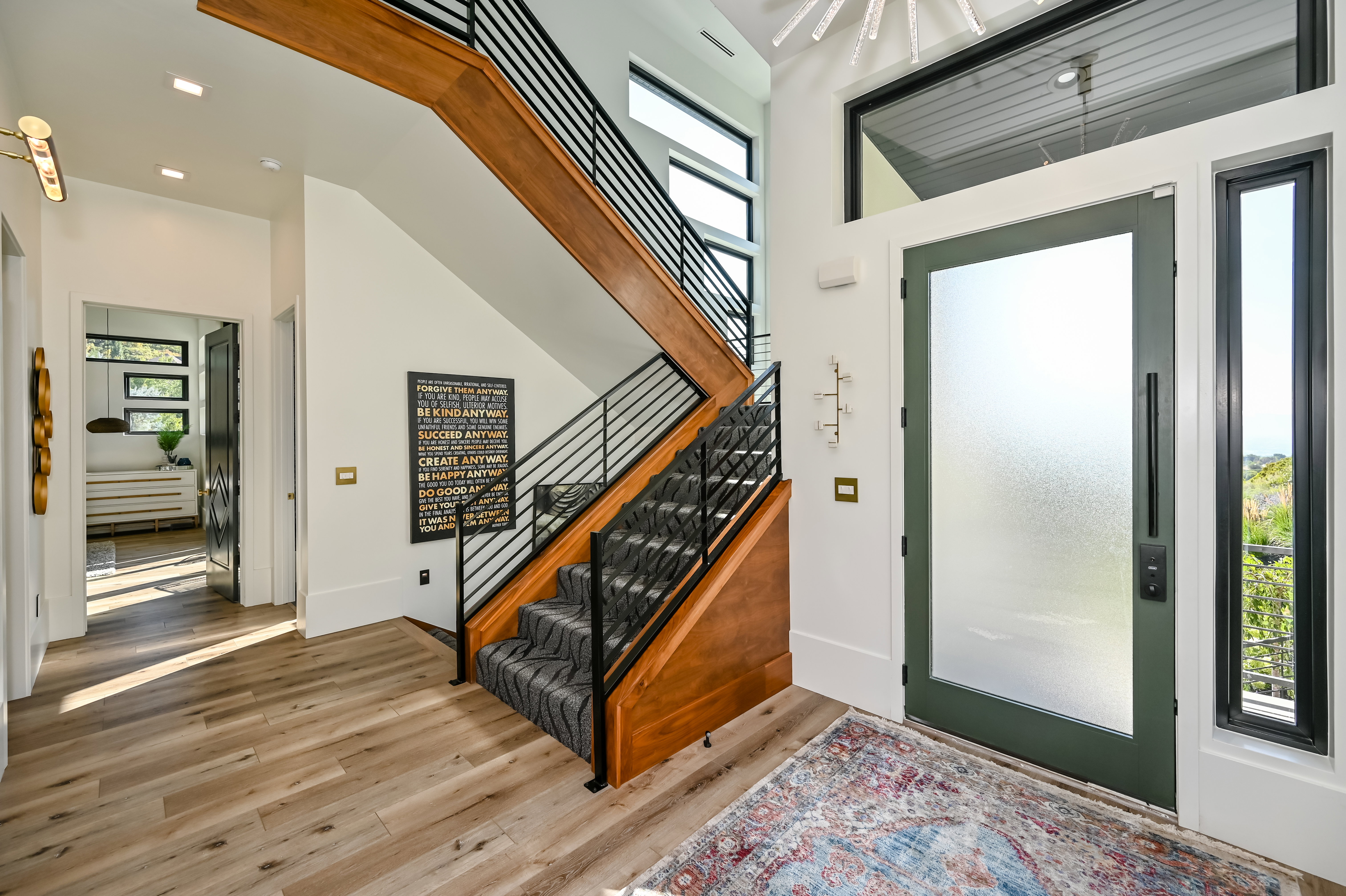 Two-story entryway with wood-finish flooring