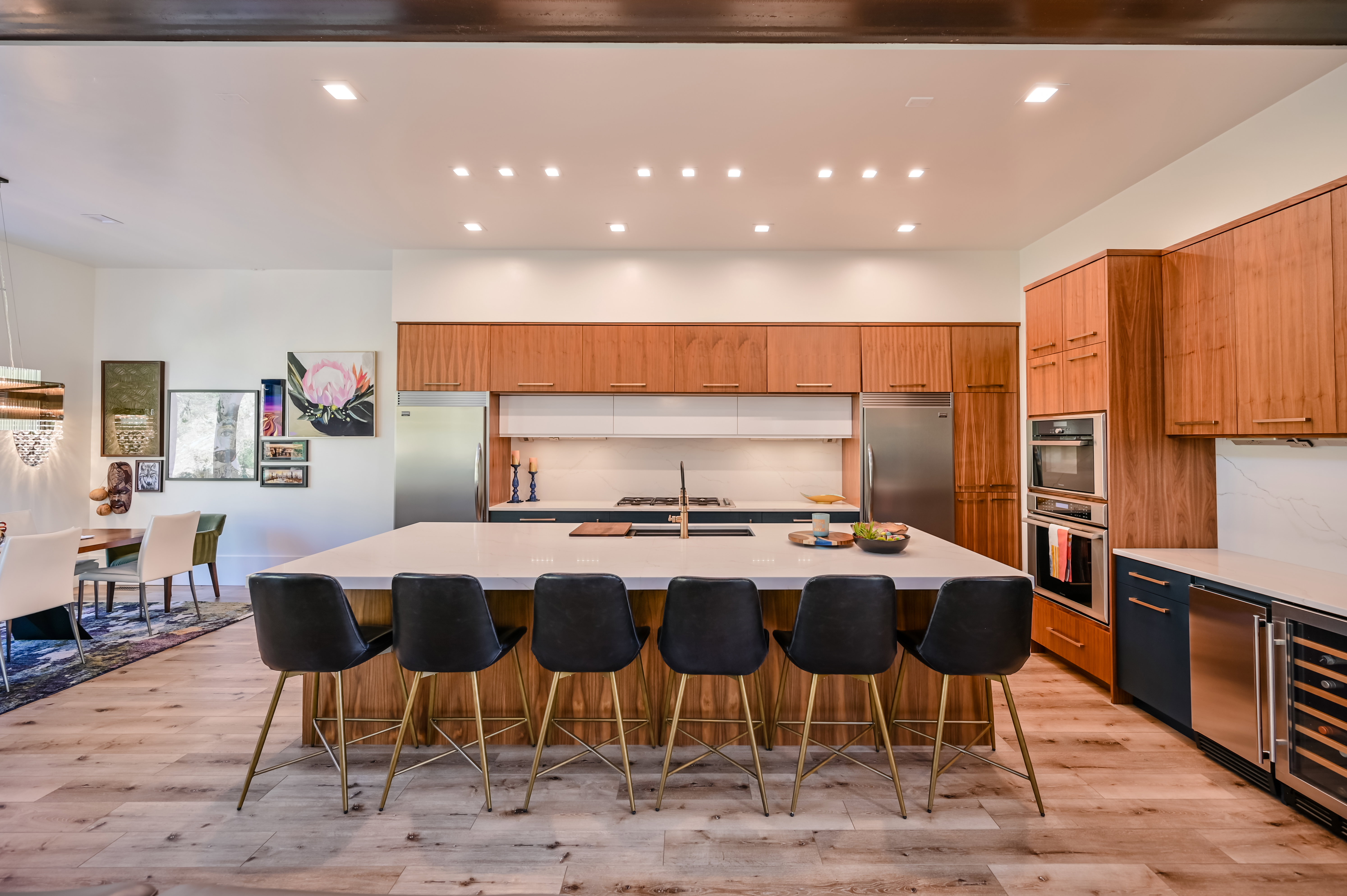 Expansive kitchen island with seating for six, featuring a light-toned countertop