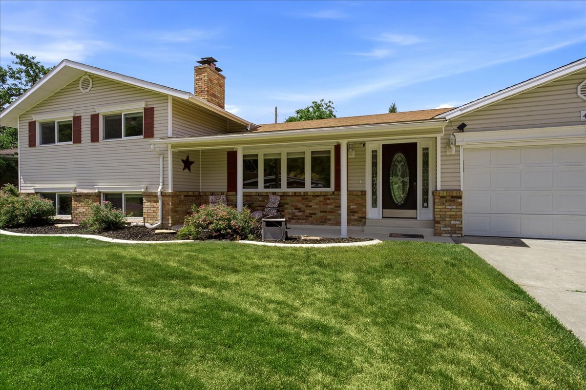 Two-story exterior featuring light-colored siding and brick accents. Grass has been digitally enhanced. Grass is not fully green in all areas.