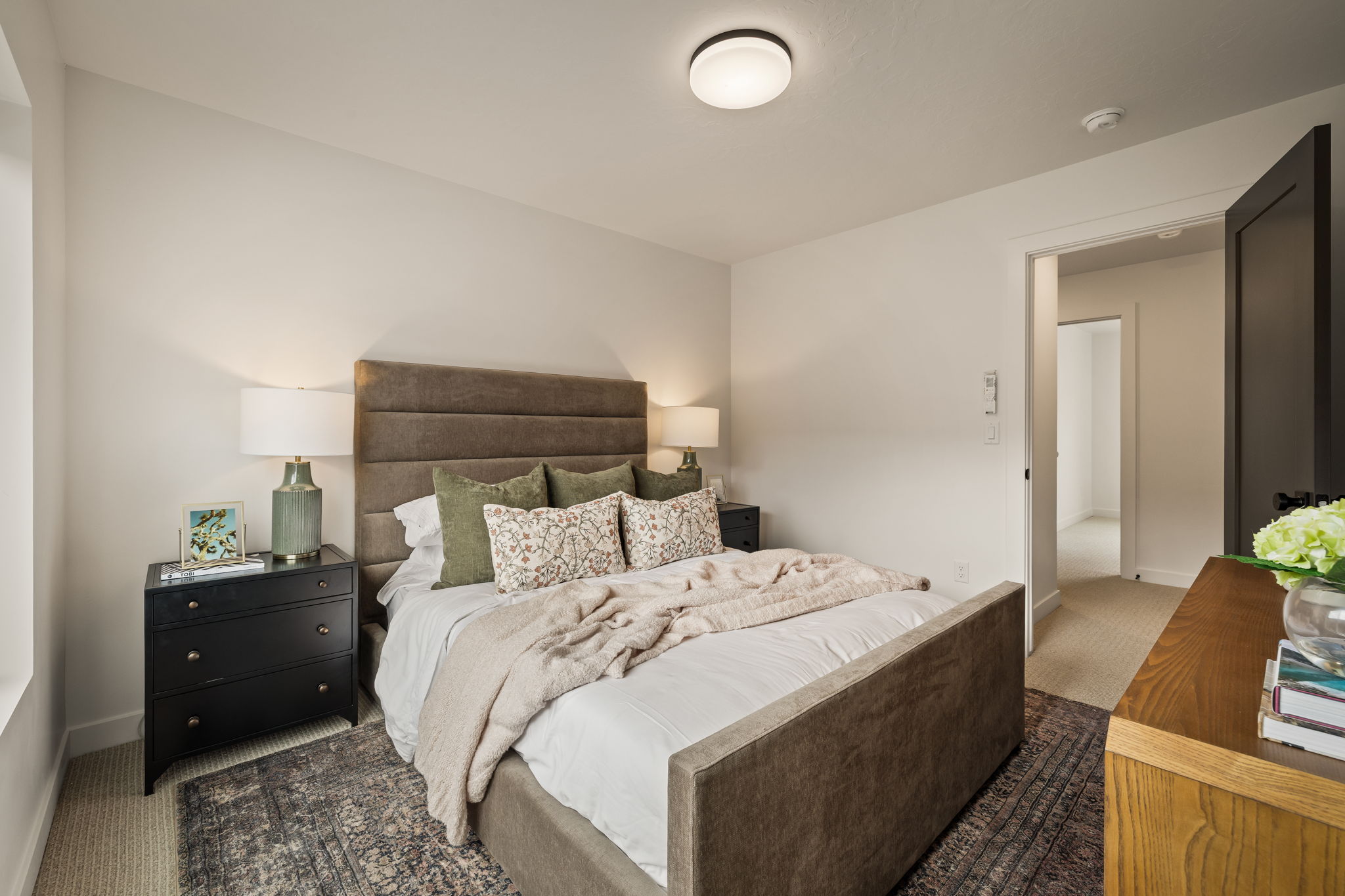 Carpeted bedroom featuring neutral wall tones and a flush-mount ceiling light fixture