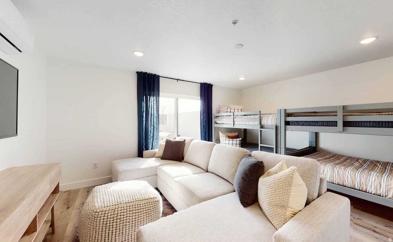 Recreational space featuring wood-finish flooring and recessed lighting