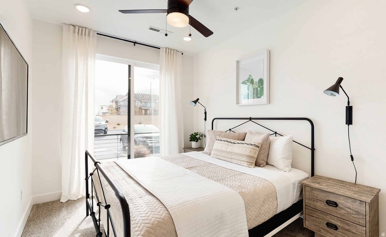 Bedroom featuring white walls, recessed lighting, and a dark-toned ceiling fan with integrated lighting